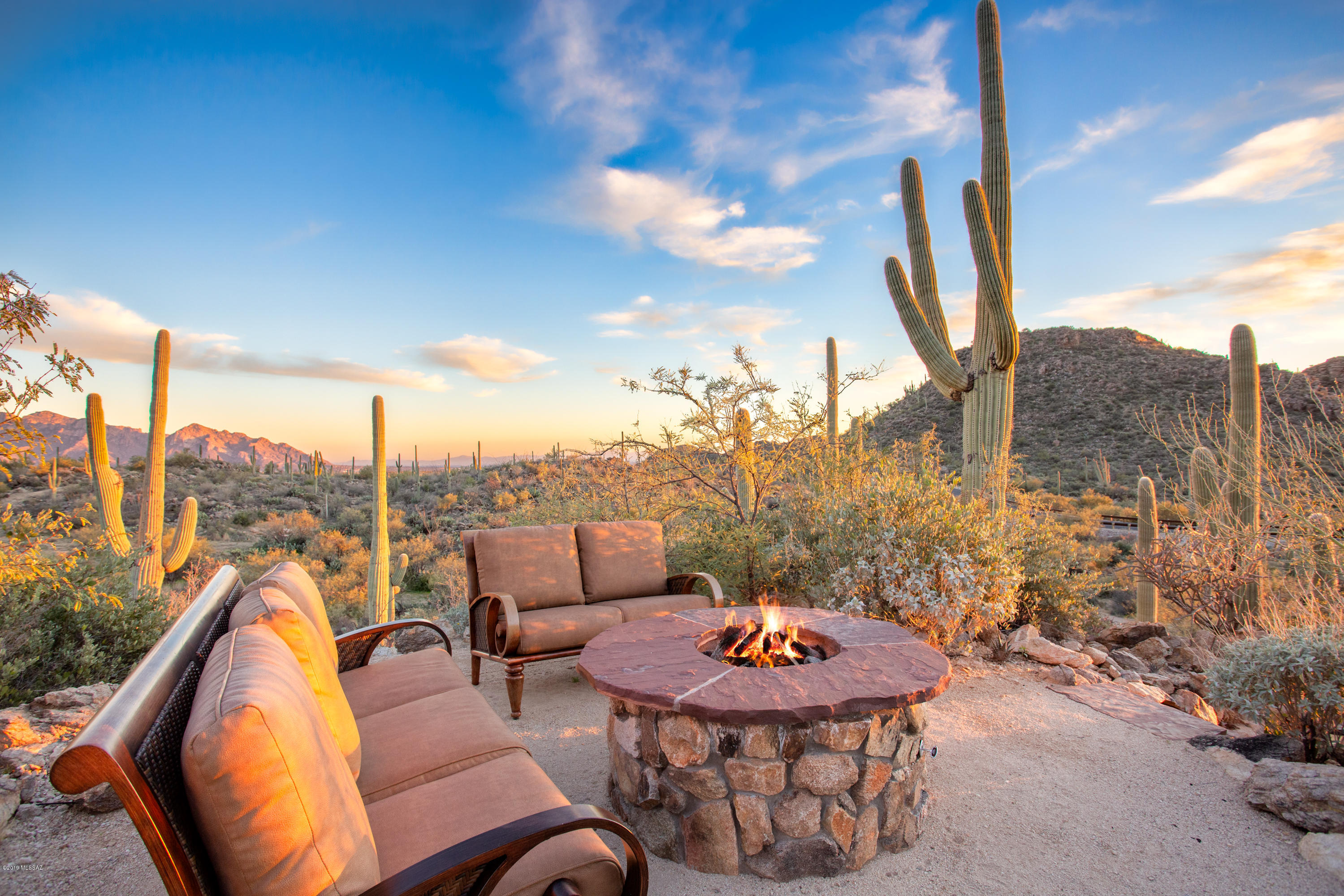SAGUARO RANCH - A HOME FOR YOUR MOST DISCERNING BUYER. Custom Southwest Contemporary on more then 4 acres - designed by Mike Franks - captures the essence of an old ranch house while incorporating the best amenities available. Drive through a private tunnel to the manned gate. The kitchen is on par w/ the finest restaurants, featuring a Bertazzoni Italia range, Wolf warming ovens, Subzero refrigerators, 3 dishwashers & more. New tile wood flooring throughout, over 150k in new landscaping, lights, palms, citrus garden, pebble tec of pool & spa. More then 5,440 sq ft of Luxury w/ 3 beds & 4 baths. Master suite expanded to add a closet for ROYALTY, new Morning Kitchen w/ sink, dishwasher, & refrig, & beautiful doors opening to secluded patio w/ spa. Huge 3 car garage. SOLD W/ ALL FURNITURE.