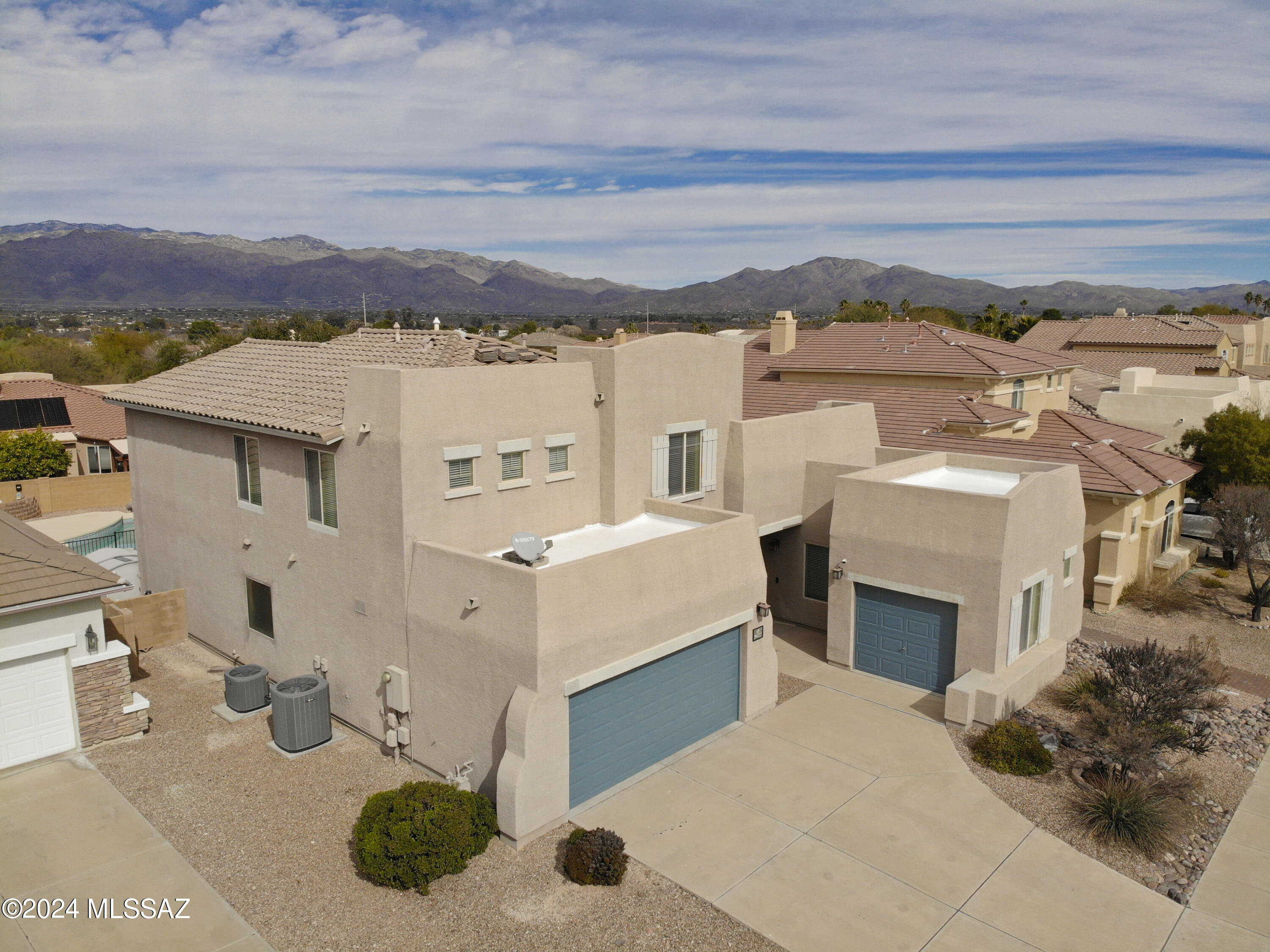 This beautifully maintained and upgraded two-story home with primary suite on the main floor has Catalina mountain views and a fully landscaped backyard with pool. Upgrades include engineered wood floors and built-in cabinetry in the downstairs office, a sound insulated bonus room with additional A/V wiring in the loft, bagless central vac, epoxy floors in both the 2-car and 1-car garages, a built-in gas BBQ next to the artificial turf lawn, a newer pool pump, 2024 water heater, and a full kitchen remodel in 2016 that extended soft-close cabinets and granite counter space into the breakfast nook. This is truly a move-in ready home with all appliances staying, including both the newer LG fridge in the kitchen and the bonus fridge in the laundry room.