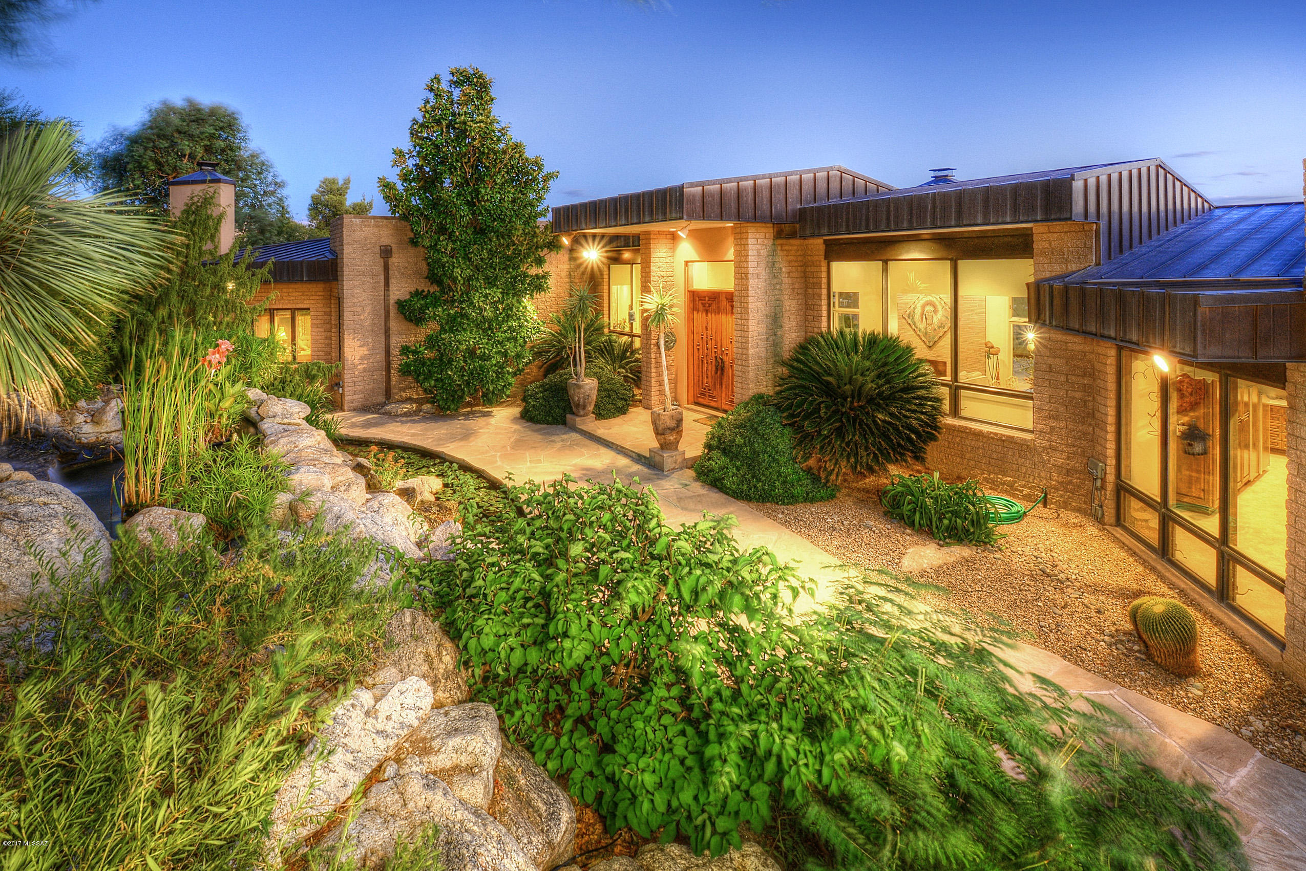 Exclusive in gated Skyline Country Club Heights offering panoramic city lights & breathtaking mountain vistas. Built by Glen Bible & impeccably maintained by one owner. This one-of-a-kind home welcomes you with a long gallery foyer & spacious great room featuring walls of glass that capture the spectacular Tucson city view. This floor plan features 2 spacious master suites which include intimate fireplaces, extra sitting room and luxurious marble & quartz master baths with jetted tubs. Gourmet kitchen has Gaggenau cooktop with deep fryer & grill, newer dishwasher, Sub Zero refrigerator &  Corian counters. Comfortable den includes wood floors, built-in cabinets & pull out desk. Outdoors enjoy the extensive covered patio, built-in BBQ, rare plants & lush landscaping.