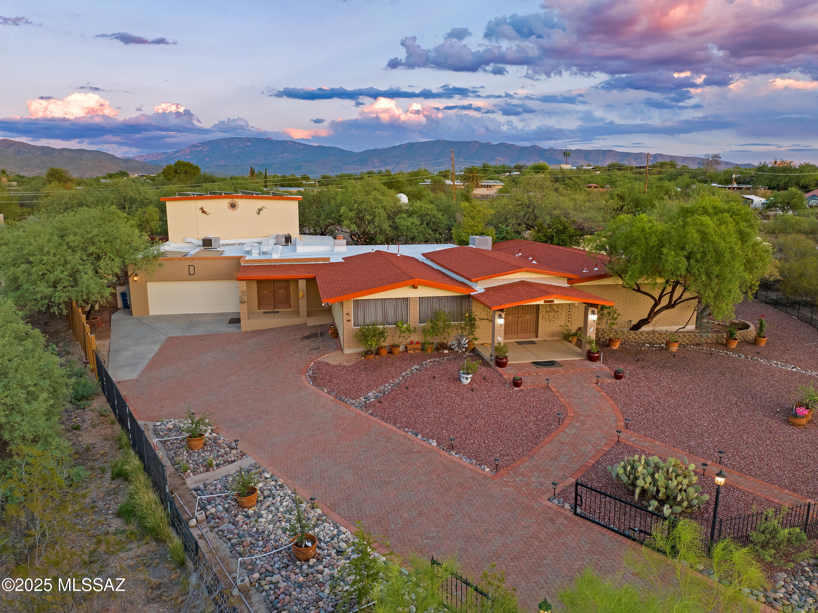 *RANGE PRICED $799,900 - $849,900*
Tucked away in one of Tucson's most coveted areas, this beautifully improved and thoughtfully expanded home is a rare find. Nestled in the serene Tanque Verde Valley at the foot of Mt. Lemmon, this expansive residence offers over 4,500 square feet of character-rich living space on nearly ¾ of an acre.

Since its purchase in 2001, the home has been completely transformed; every corner reimagined to enhance comfort, function, and style. The result is a unique blend of Southwest charm and modern convenience, ideal for both quiet living and vibrant entertaining.

Inside, you'll discover spacious living areas, custom finishes, and a stunning indoor gym and recreation room that's as versatile as it is impressive. Whether you're hosting a gathering, working out, or simply relaxing with family, this home adapts beautifully to your lifestyle.

Step outside to enjoy one of the home's true highlights: an expansive screened-in patio that feels like an extension of the living space, perfect for relaxing, dining, or enjoying the outdoors year-round. The large, private yard offers plenty of room to roam, garden, or even add a pool.

Surrounded by natural beauty and offering easy access to trails, schools, and the best of Northeast Tucson, this property is more than a home, it's a retreat. Unique, inviting, and full of surprises, this is one you won't want to miss.

Notable Features and Upgrades of the Property:
4 car tandem garage
New AC motor on 5 ton unit (July 2025)
5 ton AC and two 2 ton AC units
600 sqft. Rec Room/Gym with 20 ft. ceilings
Solar Panels (leased)
Three storage buildings (16x12 and two 10x12) (Two have power)
Two ramadas (16x12 and 10x12 with power and lights)
Entire property is walled and/or gated
Driveway gates
Landscaped with drip system 
Approximately 1,000 sqft. of covered porches
700 sqft. screened in rear porch enclosed with wrought iron
400 amp electric service box
Wrought iron windows and doors
Exterior Lights
Roof recently recoated
Exterior recently repainted