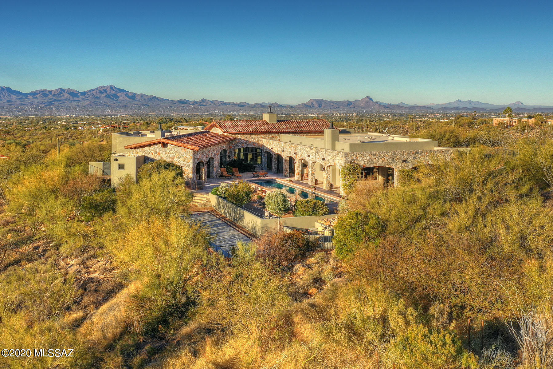 Undeniable European Elegance In This Ultra Private Estate in Coveted Pima Canyon. Perched on Over 2.5 Acres, This 5,826 Randel Jacobs Masterpiece Captures Commanding City & Mountain Views Throughout. A Gated Brick Paver Drive Leads To The Auto Court & Main Courtyard Entry. A Warm, Understated, Foyer Leads To The Grand Living & Dining Rooms w/ Exquisite Stone Work (harvested from the property), Wood Beam Ceilings, Hand Painted Murals, Walk In Wine Room, & Intimate Terrace w/ Fireplace. The Intimate Kitchen Features Wood Paneled & Hammered Copper Faced Appliances, Spacious Island, Hand Painted Mural, Butlers Pantry, and Indoor & Outdoor Dining Areas. Other Fine Features Include: Master Suite w/ Fireplace - Spacious Master Bath w/ Separate Soaking Tub - Two Walk in Closets, 3 Guest En suites, Media Room, Exercise Room w/ Cork Floors, Executive Office w/ Custom Walnut Cabinets,Travertine & Black Walnut Floors, Venetian Plaster Walls, Lap Pool & Spa, Intimate Covered Terrace w/ Fireplace, Regulation Bocce Ball Court w/ Crushed Oyster Shell Surface,  & Air Conditioned 3 Car Garage w/ Storage. This Is A Rare Opportunity to Own A Private Compound Within Pima Canyon Estates. Qualified Buyers Only.