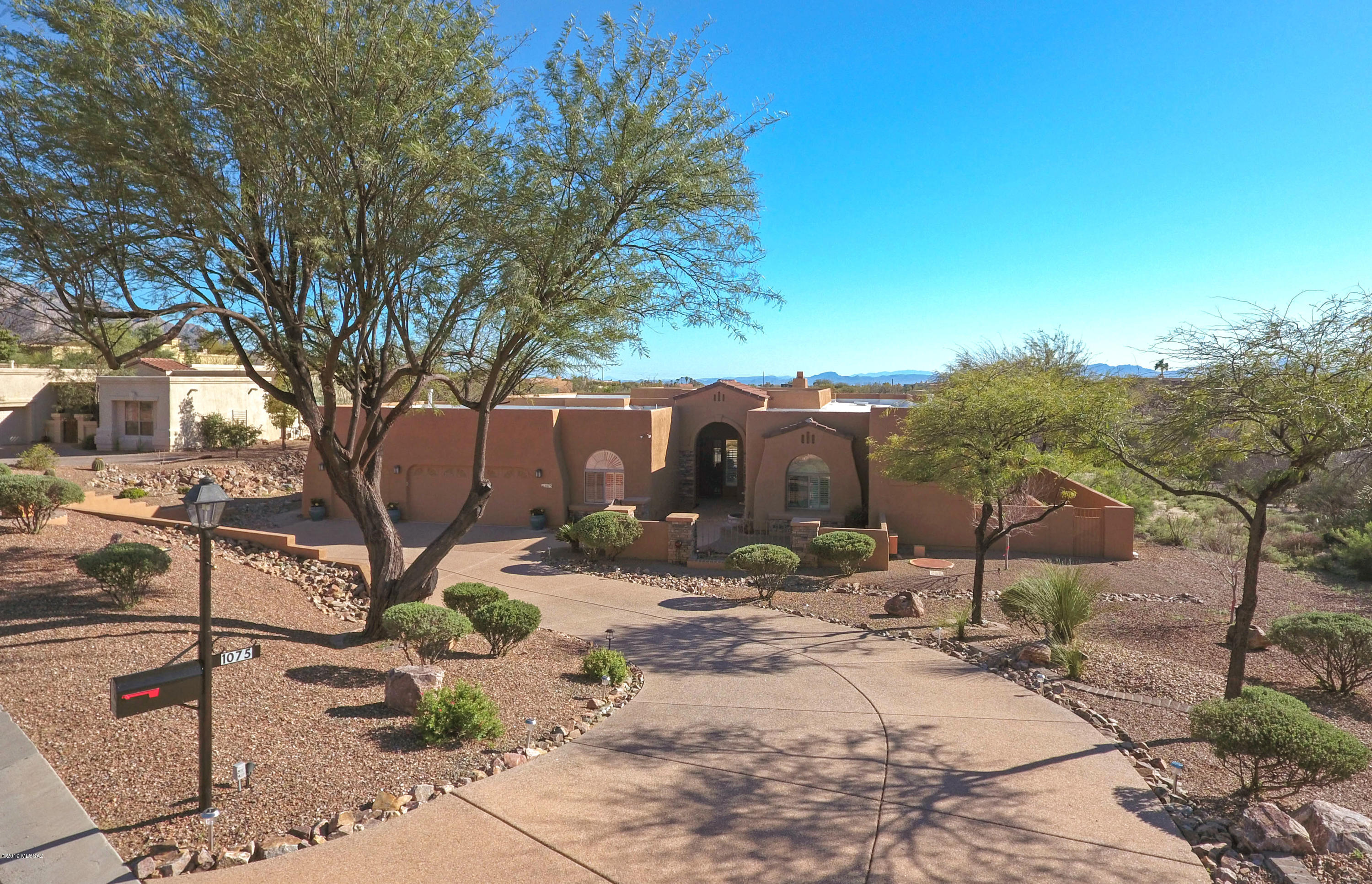 Enter thru custom gate into the charming front ctyd w/Tortolita Mtn views. Dramatic entry into huge liv/din room w/sliders showcasing the fabulous bk yd w/sparkling pebble-tec pool/spa, putting green, Bball court & Catalina Mtn views! Sunny south exposure. Gourmet kit w/granite slab c-tops, built-in Monogram frig, dbl ovens, new halogen cooktop, 42 in cabinets, 2 pantries. Spacious mstr suite has door to patio, beautiful wood floor. Sep vanities in bathrm, 6 ft soaking tub, glass blk shwr, supersized closet. Flex floor plan allows for 4 Br's or 5. Lg Br 2 can be 2nd mstr suite w/own bath. Beautiful tile thruout, new carpet in br's.  New paint inside & out. Aggregate drive & patio decks. Natural vegetation on south & west sides of home gives a lot of space & privacy. Truly a beautiful home!