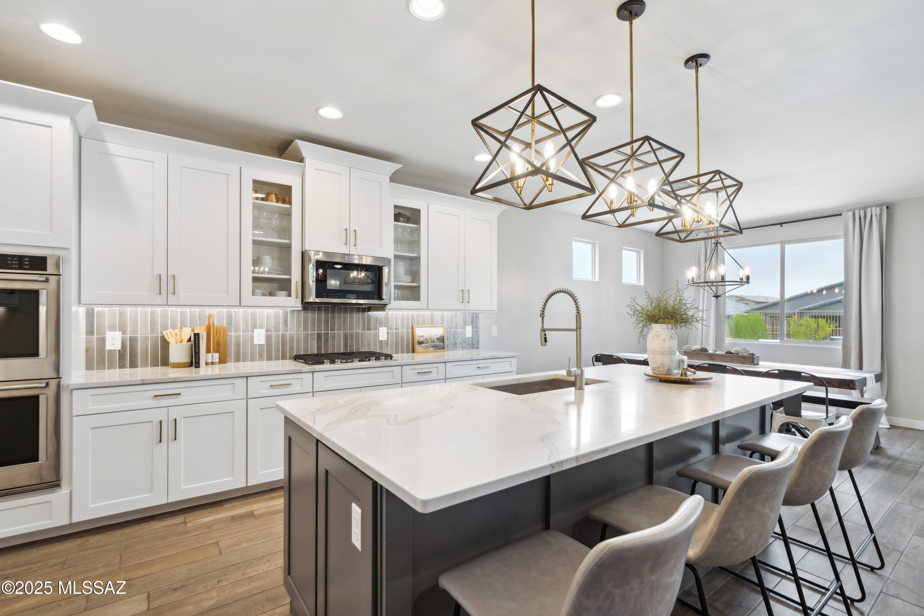 Experience upscale desert living in this stunning, newly built luxury residence nestled in the heart of Oro Valley. This beautifully upgraded 5 bed, 3 bath home boasts 3,280 sq ft of thoughtfully designed space, including den, loft & convenient guest suite on the first floor providing privacy for visitors or multigenerational living. Impeccably maintained by its sole owner, the home features an upgraded kitchen w/quartz countertops, tile backsplash, KitchenAid stainless steel appliances, dual ovens, under cabinet lighting & soft-close cabinets. Additional highlights include a 3-car garage, high-end finishes throughout, and exceptional natural light that enhances the breathtaking views from every angle. The spacious backyard is ideal for entertaining, w/extended travertine patio, artificial turf, & designated fire pit area. Don't miss your chance to own this rare find in one of Southern Arizona's most desirable communities. Owner Agent.