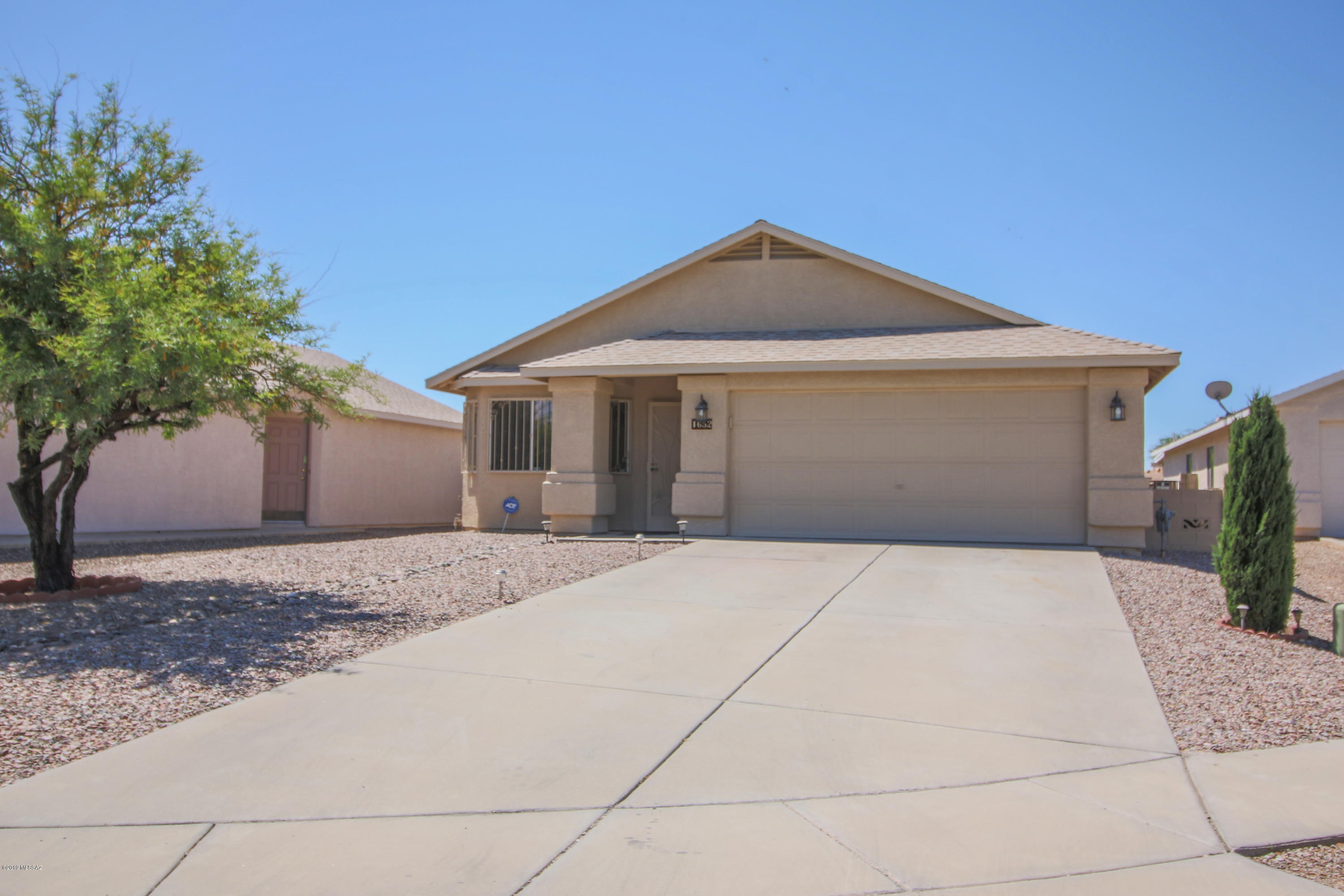 Immaculate 3 bd/2 ba home on a cul-de-sac just minutes away from the UofA, downtown and parks/recreation centers. The bright open feeling begins the moment you walk through the door into a massive great room w/ formal living area, vaulted ceilings and an abundance of natural light. Continue into kitchen w/ breakfast bar and versatile area that can be used as dining room or additional living area. Kitchen has tile countertops w/ decorative edges, updated cabinets with under-mount lighting and all appliances included. Bathrooms have been updated w/ new vanities with granite tops. Ceiling fans in every room. New roof installed 2018 and hot water heater is being replaced. Enjoy the beautiful backyard with covered patio and gated garden that has lemon tree, cantaloupes, grapes, and rosemary. Nice water feature provides soothing sound while watching the sunset light up the sky. No houses directly behind, don't miss this one!