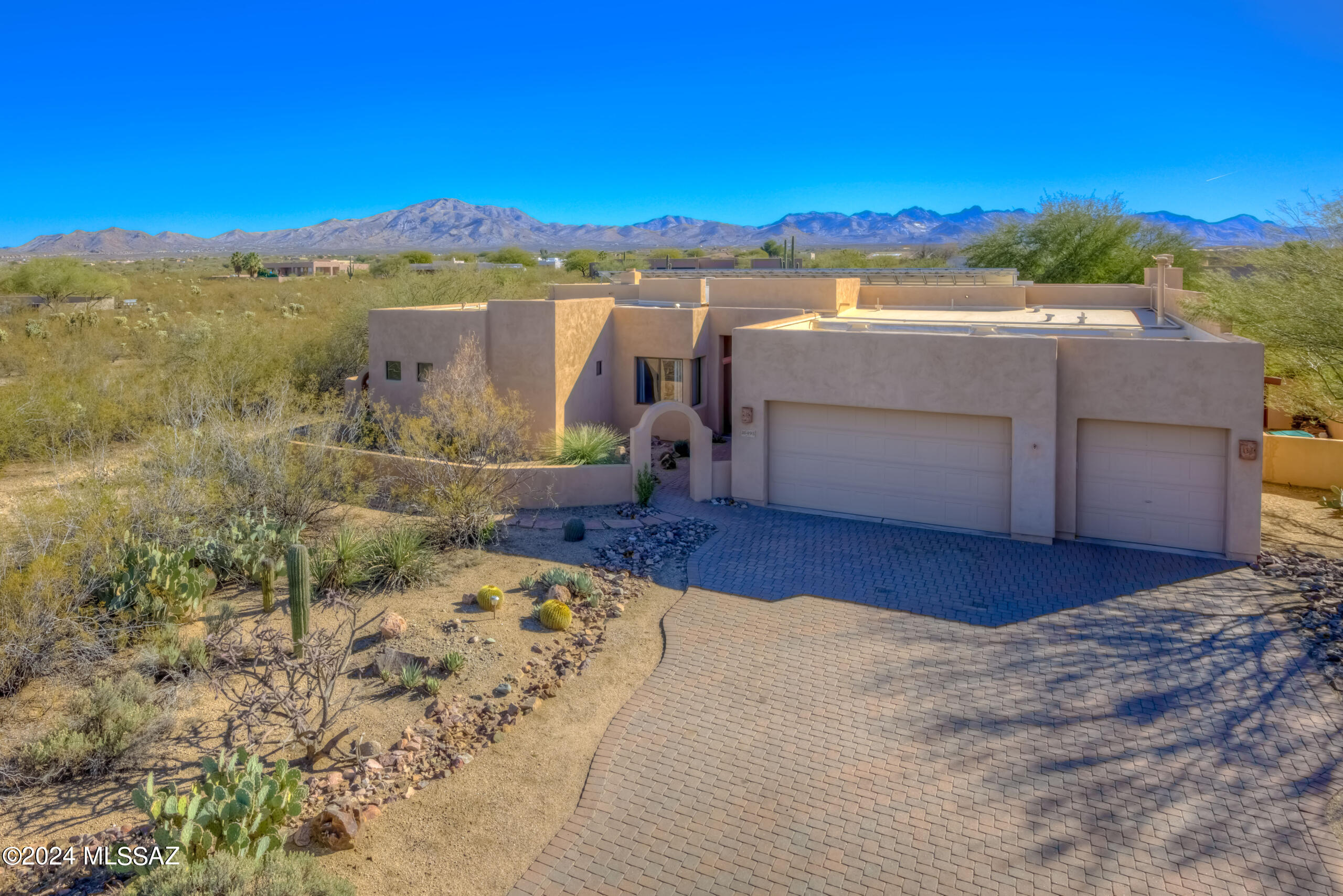 Welcome to your dream home in the highly sought-after Sycamore Hills Estates gated community! This secluded, custom built home 4BR/3BA offers a split floor plan on almost 2 acres surrounded by mountain vistas. Located on a corner lot perfect for builidng your dream shop or casita. Relax in your resort-like backyard with low maintenance landscaping, new PVC drip irrigation, and gorgeous PebbleTec heated saltwater pool with a rock waterfall perfect for entertaining. Upon entering the home your welcomed by 12 ft ceilings and panoramic windows with breathtaking mountain views from formal living/dining area, kitchen, breakfast nook & family room. The open layout bathes the interior in natural light and flows seamlessly, creating a highly functional space. The luxurious kitchen boasts a large granite slab center island, maple cabinets, double ovens, and granite counter tops that opens to the breakfast nook and airy family room. The romantic master suite has private pool access, features a slate/granite gas fireplace, and his/hers walk-in closets. Master bath encompasses dual granite counters, soaking tub, expansive walk-in shower with natural stone and travertine tile. Numerous amenities including twenty four ft depth 3 car garage, 3 fireplaces, paid in full 32 module solar system (11.04kw), paver driveway, and 50 year warranty 100% silicone roof coat.