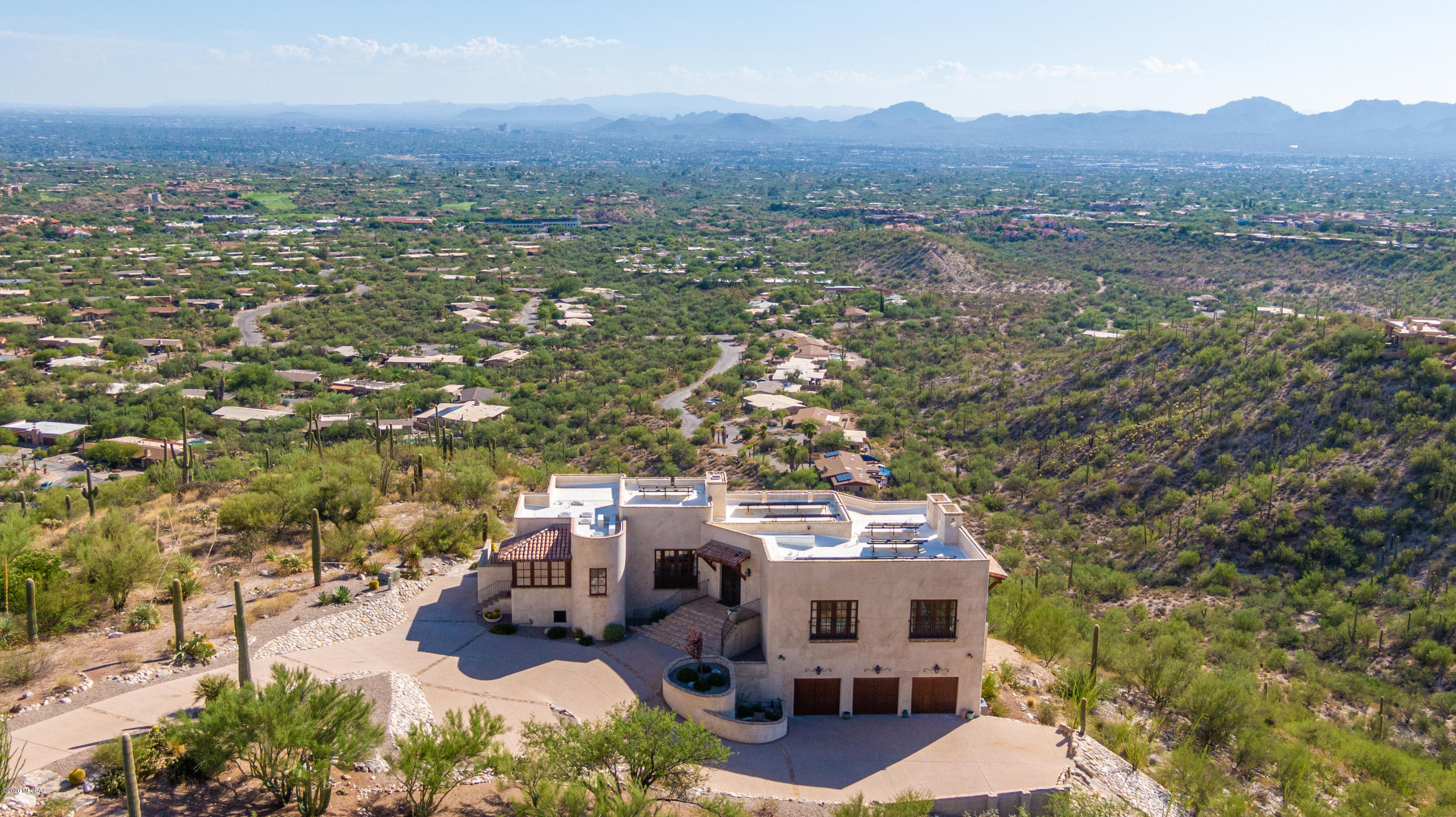 Top of the world views from this completely remodeled Mediterranean home. Located in gated Foothills II this outstanding renovation was led by Scottsdale architect Gene Kniaz Of Spiral Architects. Commanding 360 degree views from every room. Design themes taken from warm climate regions surrounding the Mediterranean create an overall feel which is authentic & comfortable. Antique & reclaimed building materials were used throughout the home to establish a core-level authenticity, including antique FP's, beams, flooring, window surrounds, & other artifacts. Magnificent new gourmet kitchen w/custom cabinetry, hand painted tiles, large island & designer appliances. Stunning backyard remodel w/new pool, spa, waterfall, plants, putting green and full outdoor kitchen will take your breath away.