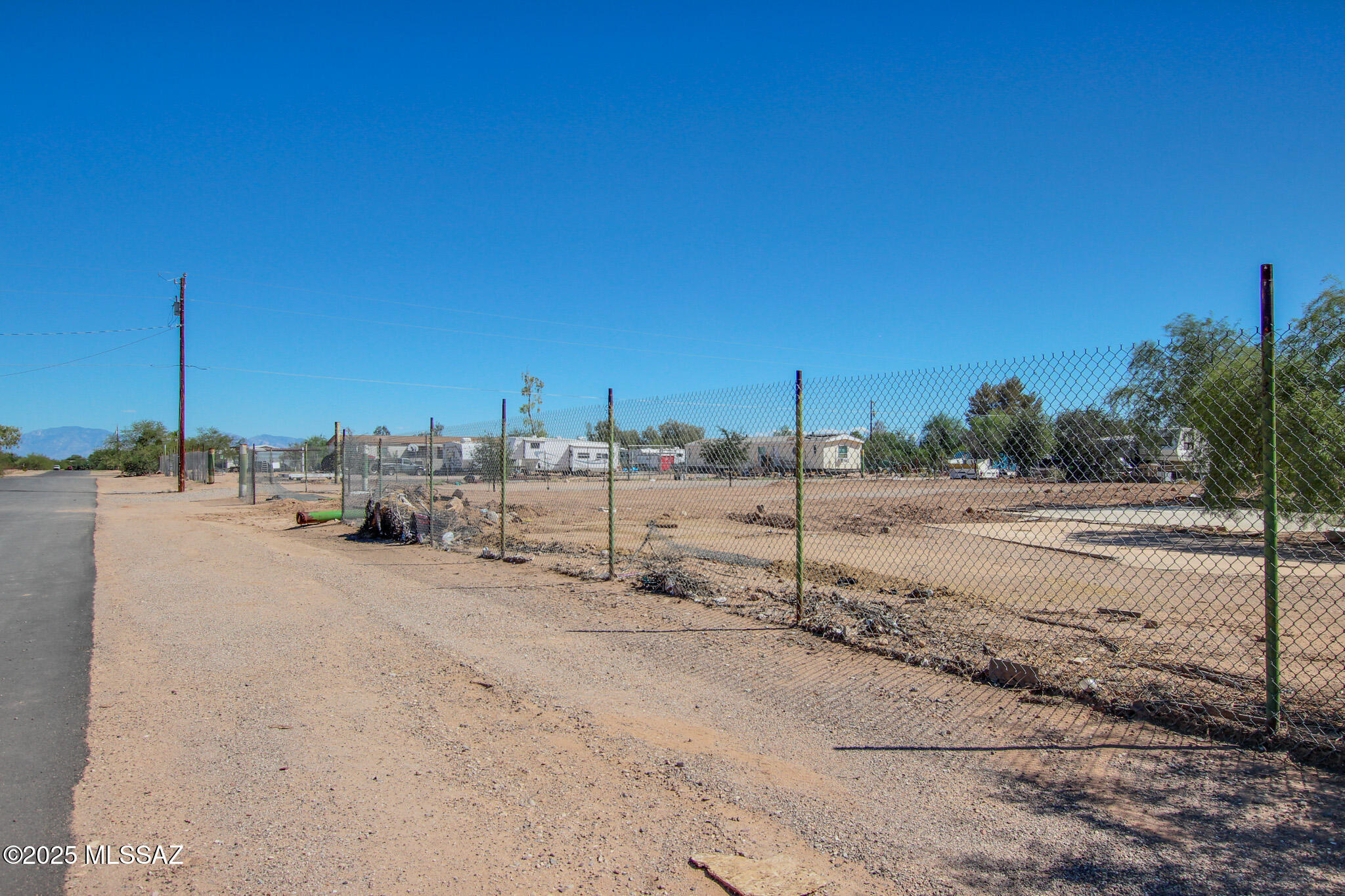 Discover the perfect blend of rural charm and modern convenience with this 1.12-acre lot zoned Pima County SH, offering flexibility for both investors and future homeowners alike. Whether you're looking to build a custom home or place a new manufactured home, this property provides endless possibilities. A previous structure has already been removed, helping you save on impact fees and start your project right away. Utilities are easily accessible—a water meter is located in the alley, and electric is available on-site; only a septic system is needed. Enjoy horse-friendly zoning and the tranquility of country living, all while being just a 10-minute drive to Downtown Marana and I-10, giving you easy access to shopping, dining, and major commuting routes.