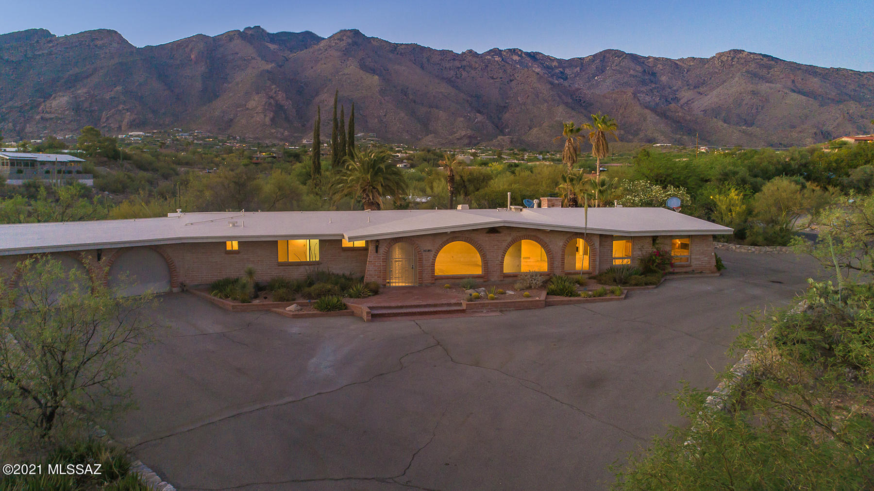 Classic Territorial Home in the heart of the Foothills, Skyline Bel Air Estates!!   This beauty sits on a 1.53 acre with scenic views of the City & Catalina Mts.   Spacious entry leads to living/dinning rooms with wall of windows  custom ash cabinetry built ins throughout, Travertine tile, Over sized game/billiard room & bar,  loads of cabinet and counters space in this custom built kitchen with granite counters,  breakfast area over looks family room with fireplace & bookcase, Master suite has custom built in closet & double vanities, laundry room has storage and 1/2 bath for swimming pool use, charming patio and pebble tech pool,  Built in gas BBQ.  Westside gate access to garage.  Community Pool & Tennis courts too! 1/2 acre behind has separate tax code. Come take a look