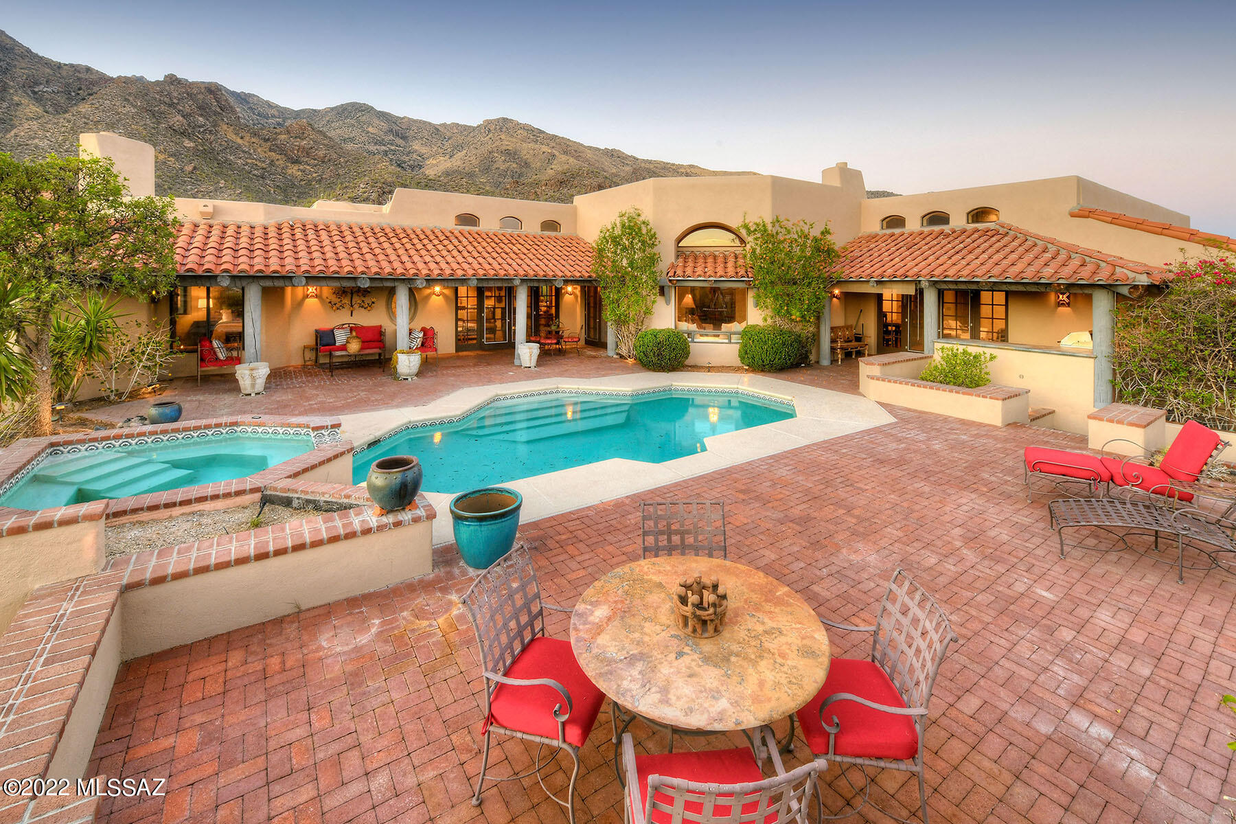 A rare opportunity to find city & mtn views in prestigious manned gated Finisterra Estates. Front courtyd w/antique hand carved wooden front entry doors, 4,292sqft, exquisite living rm w/lg picture windows,14ft high beam ceilings,dramatic fireplace,formal dining rm, light & open kitchen, beautiful talavera tile countertops, stainless steel appliances,6 burner gas range,Sub-Zero,butler's pantry,brkfst rm,cozy fam rm off kitchen,brick flrs,beam ceilings & French doors thruout, lg rec rm/library,3 bedrms+study w/built-ins or 4 bedrms & 4 baths incl master w/sitting area, fireplc, lux bath w/marble & designer tile,garden tub,lg shower,closet w/wood flrs. Enjoy resort-like bkyd w/covd brick patio,gas heated pool,spa,lush landscaping,fruit trees,city views,comm pool,spa,tennis & Dist16 schools.