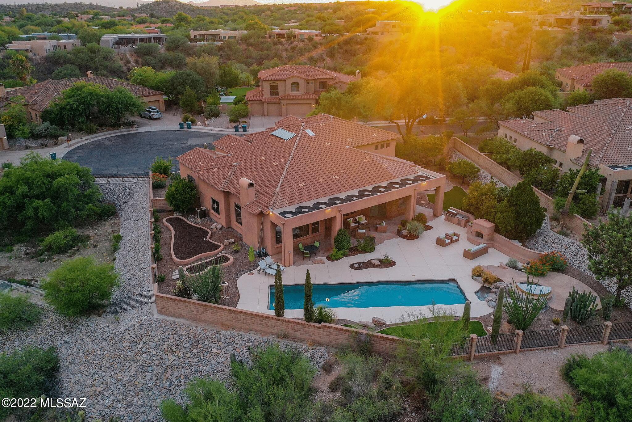Open Sunday 10-16 (1-4 pm) Stunning! 5 Br/4 Ba in the best location with the best views.  Sellers are original owners. They chose this lot for the huge Mountain and City views. Begin the tour with artist designed, ''Tree of Life'', iron front door, step inside to the dream floor plan. Master suite downstairs plus 5th.  bedroom with adjacent bath also on first floor. Formal and informal areas with a family friendly upstairs including a media/game room. Outside is as nice as most resorts with the solar heated, electric retracting cover lap pool, hot tub and waterfall. Built in grill with sink + outdoor fireplace for outside fun. Don't miss the inground trampoline, ,artificial grass areas and raised bed gardens. The cul-de-sac location gives extra privacy . 4 car gar. roof replaced 2013