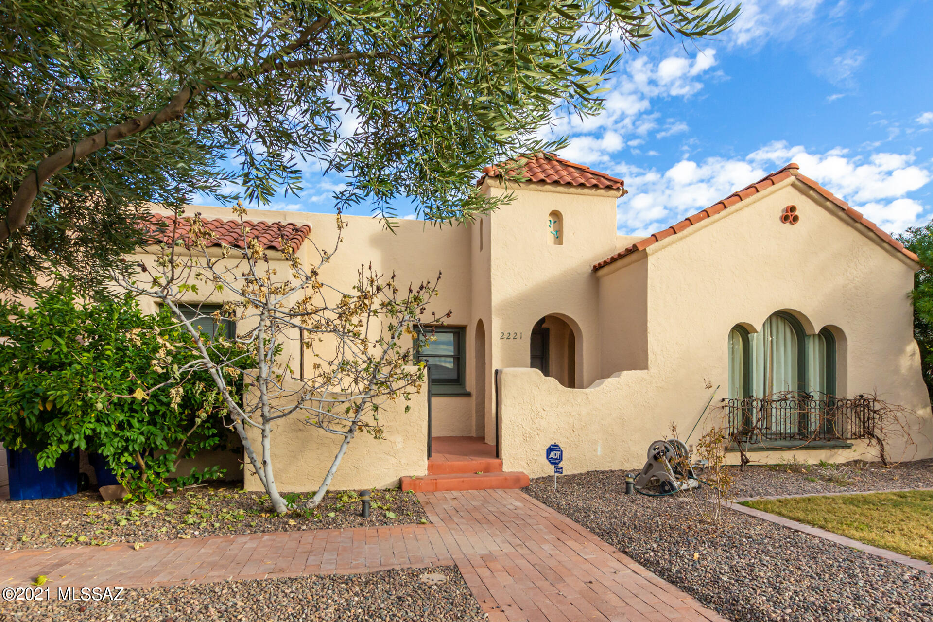 CHARMING HISTORIC HOME in Speedway Heights! So much to offer on this large 8837 sqft lot with a 3 bed, 2 bath home (1795 sqft) in front and a 1/1 Guest House (523 sqft) in the back! Enter the private front yard through an arched gateway. New landscaping front and back. Paver path leads to the classic portico and curved front door. Come inside to experience the character of coved ceilings and curved archways that blend beautifully with updated features that make this home so special.  The spacious living/dining room has upgraded lighting, hardwood floors, freshly painted and inviting stone fireplace. Immaculate Chefs kitchen with quality wood cabinets, crown molding, SS appliances, quartz counters, and breakfast bar. The grand master bedroom boasts backyard access, a walk-in closet and ensuite w/granite & dual sinks. Cozy guest house in the backyard with kitchen, living room, 1 bed & 1 bath. Sizable backyard with relaxing covered patio, mature shade trees and gorgeous fountain. Rock climbing pyramid will convey with the sale or can be removed if buyer requests. Don't forget the large 3 car garage, an amazing feature in this neighborhood. New HVAC in 2021. Multiple energy upgrades including Nest thermostat, new windows in the Guest House and duct sealing. The garage has an electric door opener and an EV charging station (a free 240-volt outlet for level 2 charging). The alley driveway has uncovered RV parking to accommodate a class B vehicle. Within walking distance to Banner, U of A and Himmel Park. Close to restaurants, and shopping! A great opportunity! Call now!