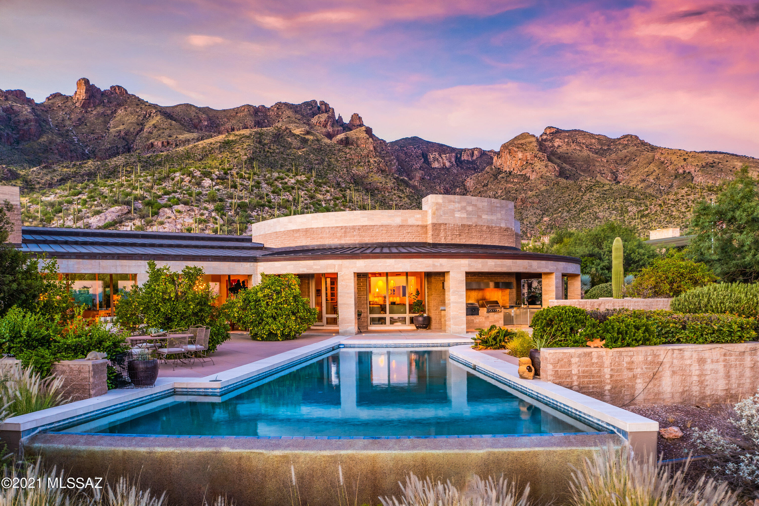 Contemporary masterpiece w/bold forms expertly crafted on a spectacular view lot; copper standing seam roof, integrated split faced block construction & travertine wall panels inspired by the Getty Museum; Show-stopping walls of glass frame astounding mountain views & twinkling city lights, Beamed ceilings soar to over 17ft in stunning architectural design, French limestone floors, artistic custom lighting, chef's kitchen w/French oak parquet floors, open to stunning Great Room, custom glass paneled cabinets, sleek stainless appliances, Grand butler's pantry, casual & elegant dining areas, Spectacular owner's suite w/separate luxe baths, fp, exercise rm & dual custom closets! Sweeping view patios, stunning neg edge pool; PLS CLICK ON THE 'DOCUMENTS TAB FOR DETAILED 2-PAGE FEATURES LIST