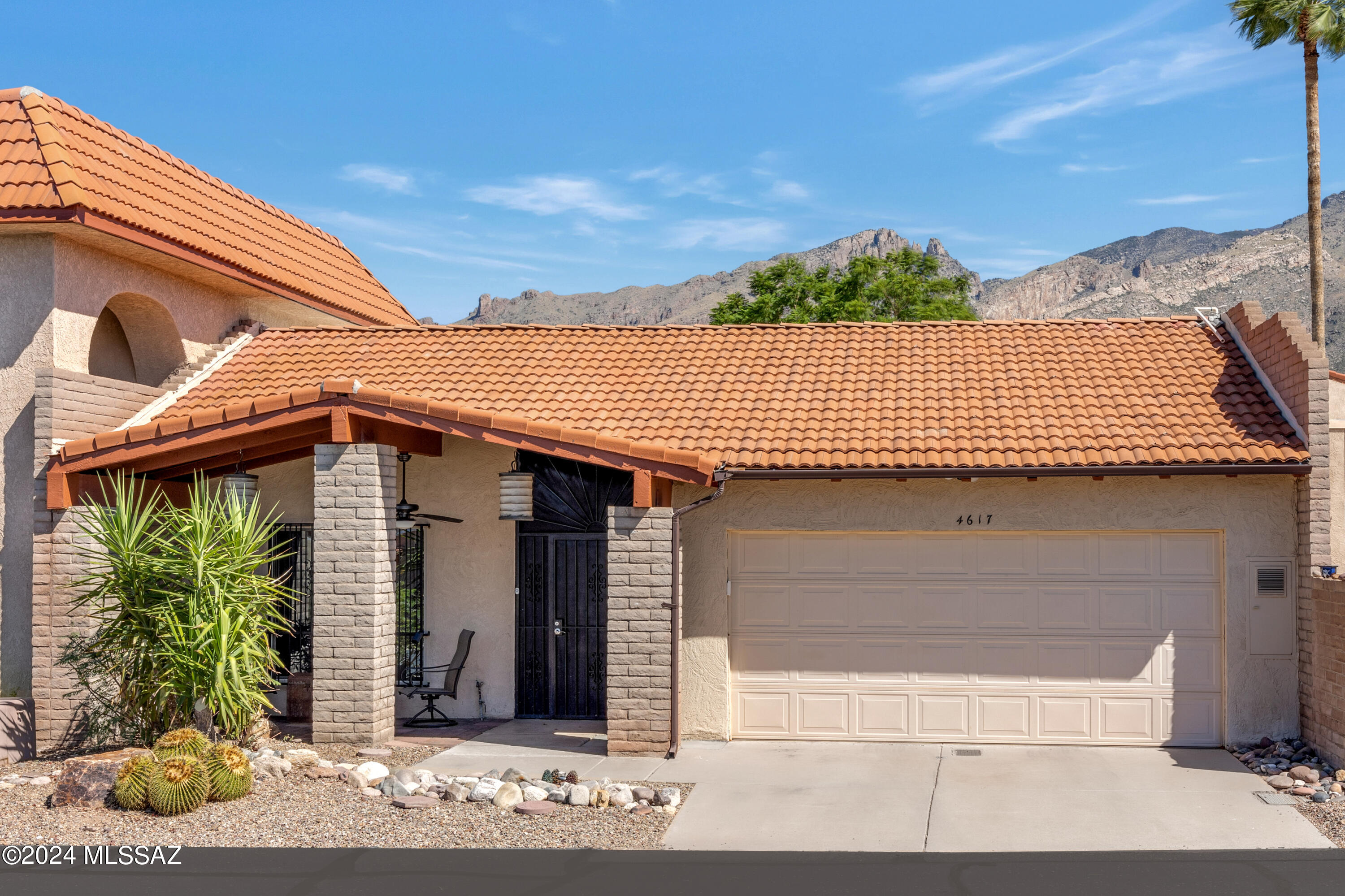 Spacious townhome in the heart of the Foothills with 2 bedrooms, 2 baths, plus a den/office which could be a third bedroom. Dual sided fireplace makes this floorplan a favorite.   Updated & atriums removed. New natural wood beams & additional skylights create warm inviting living spaces. The kitchen features granite countertops & opens to the family room and dining area.  Other highlights include tile floors throughout, only one small step into den/office, flat entry showers, W/D in primary closet, rain harvesting, 2 car garage, gated front entry, & district 16 schools. Community features 2 pools (1 heated), spa, gym, clubhouse, playground, basketball-pickleball-tennis courts. The HOA also includes Xfinity cable & internet, trash, & front landscaping.