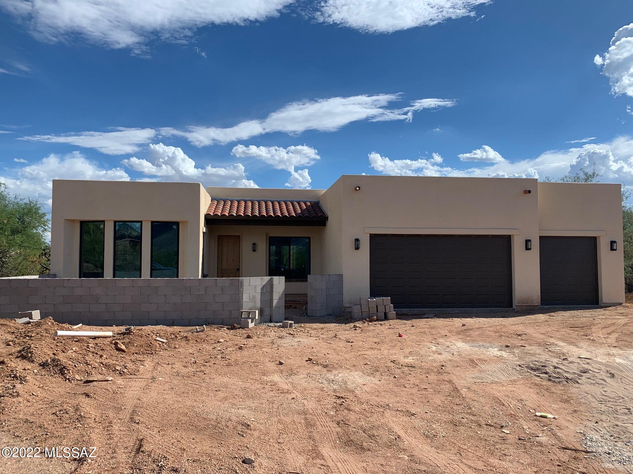 Seller will consider offers ibetween 800K- 825K. In the desirable Tanque Verde Valley in Northeast Tucson, this custom built home is sited on back of a cul-de-sac lot.  Great Room with soaring high beamed ceilings, fireplace and media wall,  scored concrete flooring,  gorgeous custom Davis Kitchen, Granite countertops and 8'  island with seating.  Separate dining or office area.  Split bedroom floorplan.  Owner's Suite featuring dual vanity, spacious walk in closet, separate tub and shower.  Large laundry/storage room.  Generous 3 car garage, with storage.  Front landscape will finish with a masonry stucco courtyard accented with adobe columns, back  is currently natural desert.  Lot access from back of lot is available for future pool build, if desired.  Expected completion earl July 2022