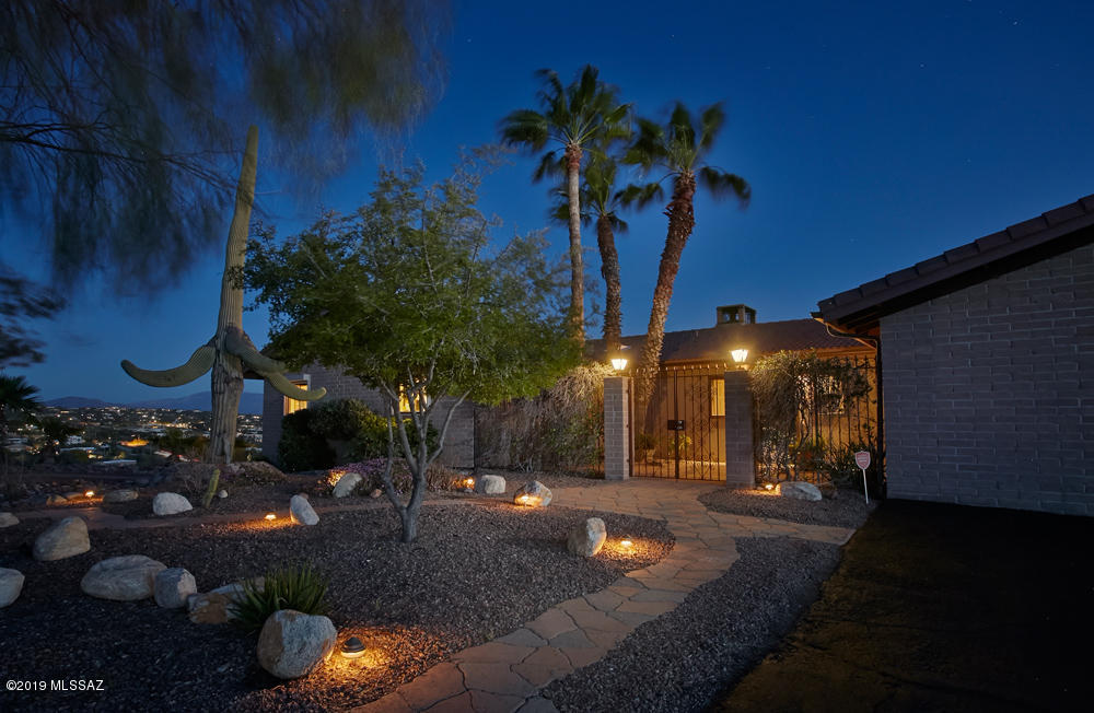 If you value views, this is the house for you!  The city lights and mountain vistas are amazing from this 1+ acre lot.   Great outdoor entertaining space with a lap pool, covered deck, fire pit and more.  The 4BR/3BA house features a great room and family room w/2-sided FP, spacious dining room and delightful kitchen.  MBR has private deck and spa-like bath. 2 guest rooms with a full bath complete the picture. Downstairs is another BR w/ensuite bath and private entry.  Lovely courtyard gives this house special appeal. Voluntary HOA!