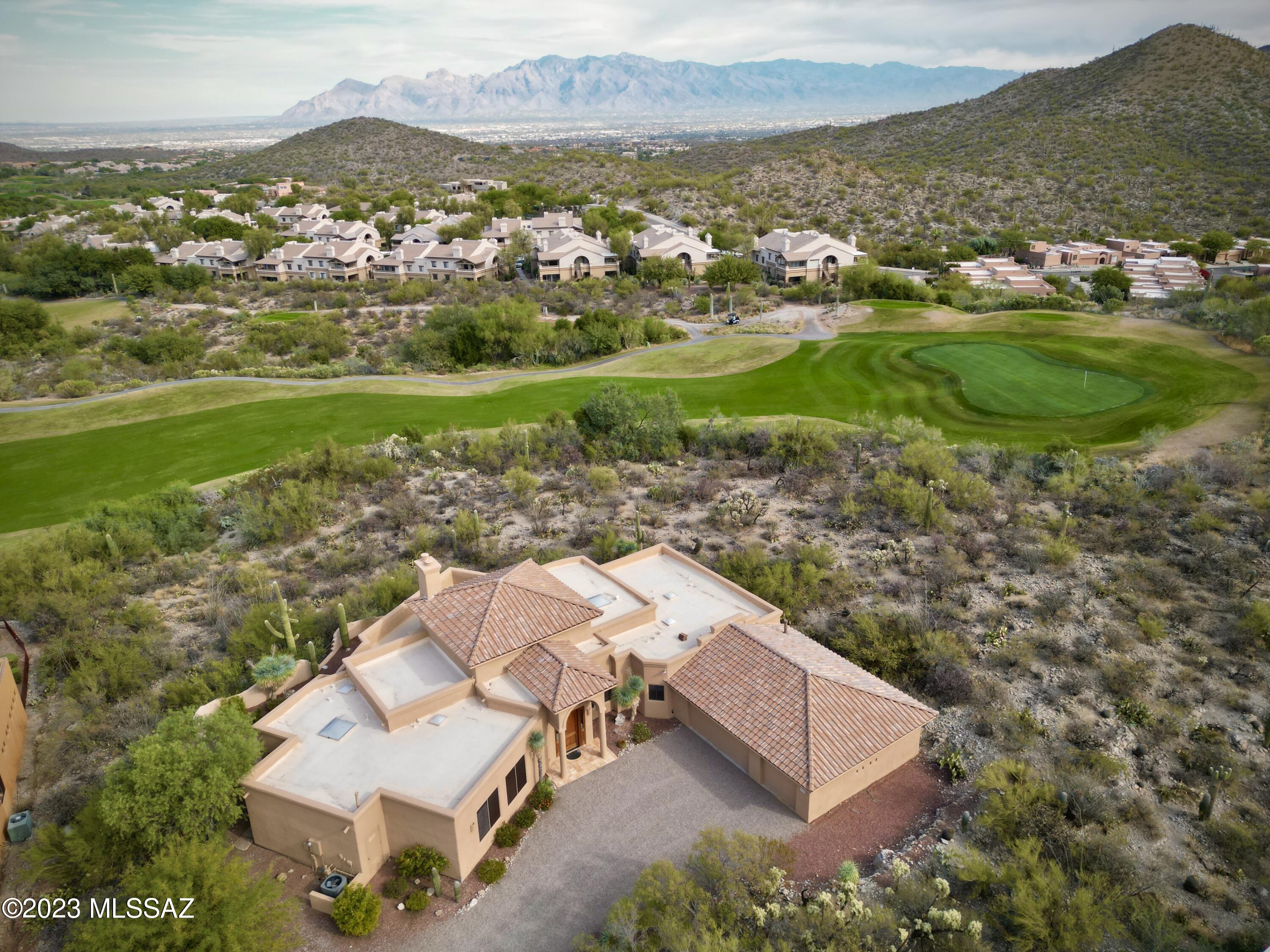 Unobstructed mountain and golf course views with a rooftop view deck complete with indoor/outdoor seating areas. It's a perfect place to unwind and take in the breathtaking, majestic mountain and golf course views. Situated on a serene cul-de-sac golf course lot, this home is an exquisite gem spanning almost a half an acre, providing you with ample space and tranquility. Featuring a newer tile portion of roof which has a transferrable 15-year warranty (done in April '22). You won't have to worry about much exterior maintenance here! All the parapets have been recently repaired and the entire exterior of the home was re-painted. This home boasts an oversized primary bathroom with double walk-in closets, a split bedroom floor plan and thoughtful jack and jill bathroom, connecting two of the guest bedrooms. This convenient design is ideal for families and guests. Don't miss the opportunity to enjoy the perfect blend of comfort, style and natural beauty. Home has been gently lived in. One-owner property (snow birds) who only lived here part-time..