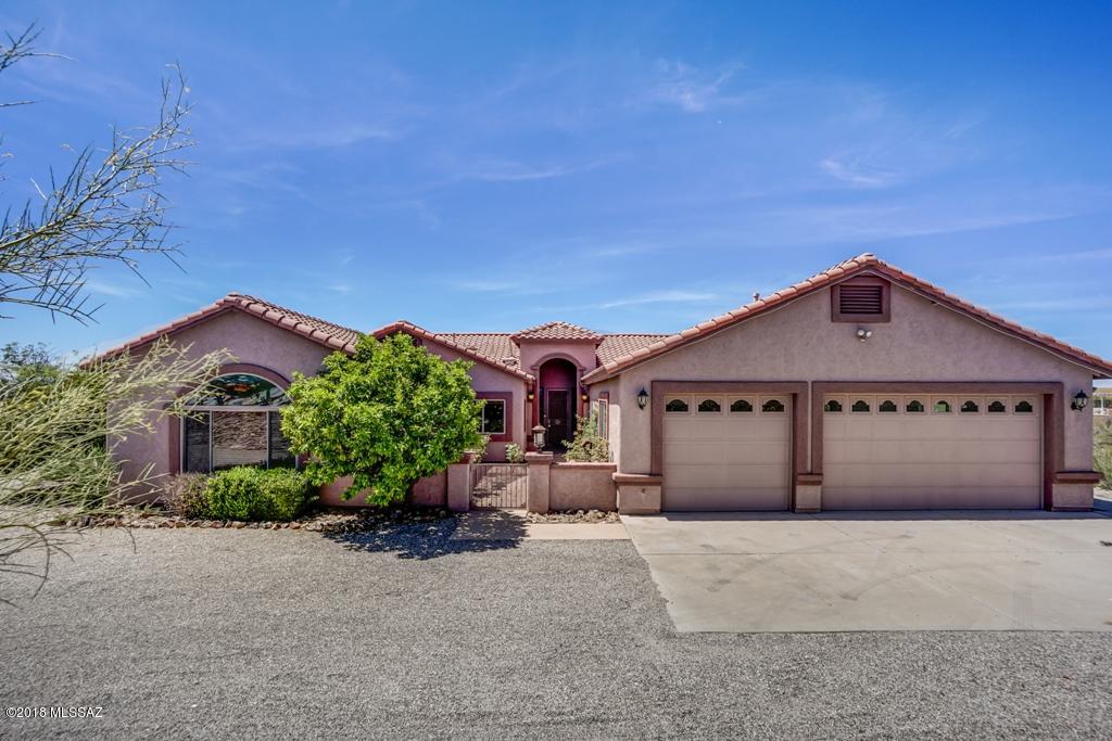 Gorgeous Custom Built 4 Bdrm/ 3.5 bath Home on acreage with Stunning Views. Huge Great room is perfect for formal dining & entertaining. Kitchen off family room has loads of cabinets, granite, Island, and breakfast bar. Ceiling fans, tile flooring, high ceilings throughout.3- bedrooms with full baths. Half bath off kitchen. Two master suites both with walk in closets, dual bath vanities, and spa tubs/separate shower. Enclosed heated and cooled Arizona room with closets. Washer/Dryer hook-up in laundry room with sink. Relax and enjoy the full length patio, low care backyard landscaping w/turf and open panoramic mountain views. 3-car garage. TUSD Schools. Solar home with electrical panel service, tenant will pay a flat rate of $150/mo. for electric. Refrig & BBQ as is. Lots of upgrades and r
