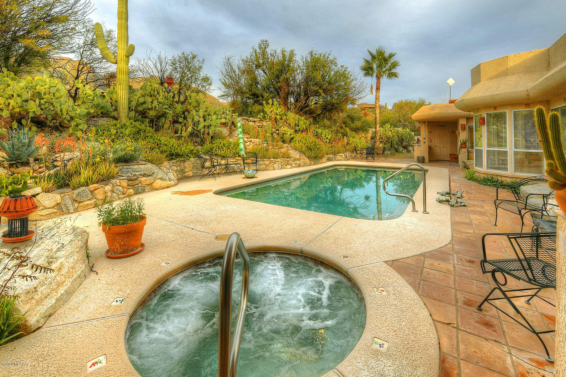 Custom built Catalina Foothills home w/ Panoramic Views, Total Privacy, 81 Tubed Skylights, 4,477 SF, 6 Bedroom/5 Baths, Sparkling Pool & Spa on 1.24 Acres. Enter into large Foyer. Continue into living space of Family & Living Rooms joined by 
2-sided Fire Place and Kitchen. Wall of Windows give you total nature- bringing the outside in. Formal Dining Room-Counters & Views. Breakfast nook w/Bay Window. Screened in Arbor. Pyramid of Flowers Included. 4 corners of home w/combined bedrooms& baths. 1 w/ an Office & Studio. Guest Quarters w/ Separate Entry has kitchenette, 2 or 3 bedrooms, 1 a Living or Playroom. Storage everywhere. Laundry room with View, 3 Pantry's, 3 Car Garage w/ Separate Storage Areas. 4 HVAC for Energy Efficiency. Original Architect/Owner. See attached feature list.
