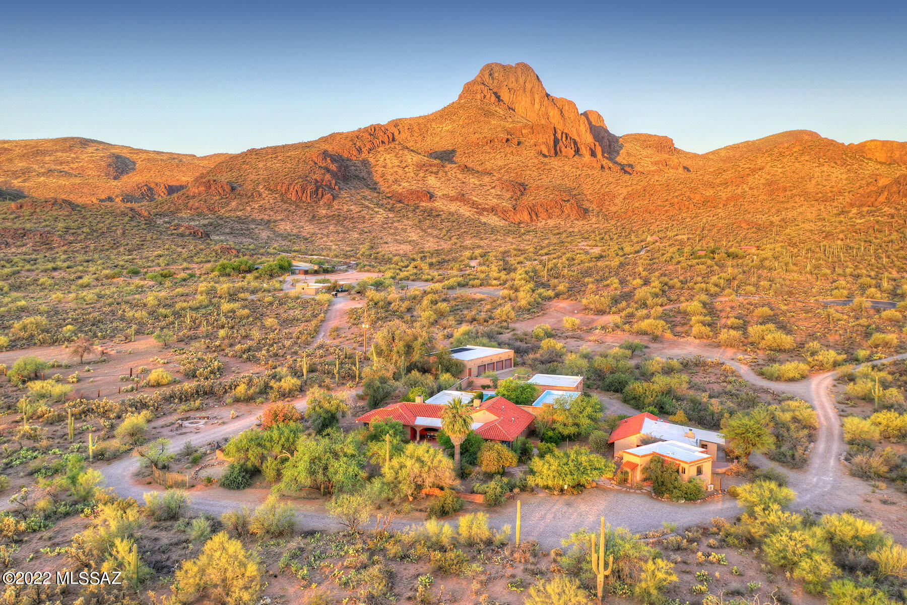 Historic Black Arrow Lodge Hacienda, built in 1949, rich in heritage & elegant style, presents a rare opportunity for the discerning buyer.  Its 7.8 private acres at the base of Safford Peak & a few hundred yards from Saguaro National Park & Sanctuary Cove provide a serene & majestic setting for this gracious estate. Styled with beamed ceilings, original Mexican mosaico tile, intimate courtyards, fountains, arched entries & many antique elements collectively create the feel of Spanish missions of yesteryear.  Main house offers 3 bd/2.5 baths, library, great room, formal dining, renovated kitchen, office w/ prvt entrance, & a media rm or 2nd office. Two guest houses. Sparkling new pool remodel w/ solar has changing rm with full bath. 2 viewing/sleeping decks, 4 fireplaces, 8 car freestanding garage w/ office, double RV freestanding garage, basement, new private well in 2017.  Property can be split in half per zoning. Ideal for family compound, Airbnb, equestrian ranch, or a gracious place to host guests.  With major renovations completed, this attractive price allows for the new owner to make any necessary improvements or finish any updating to their own liking. This hacienda-style estate, once featured in Phoenix Home & Garden, features a great room & primary bedroom suite designed by Lewis Hall, a protege of Josias Joesler. The property is secured with a private gated entrance.  Additional photos upon request.