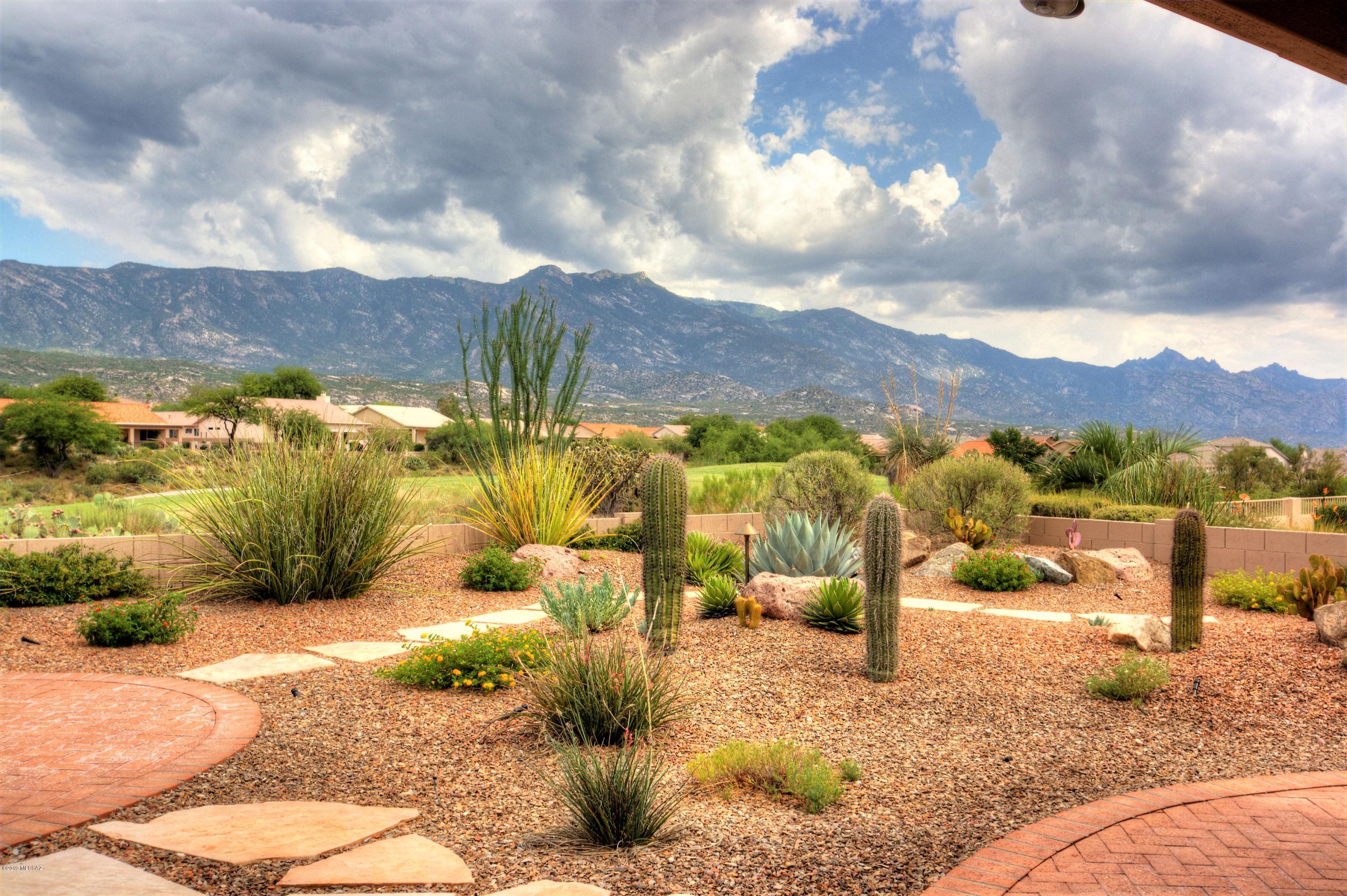 Beautifully updated Laredo on the golf course with unobstructed views of Catalina mts.  New, tile floors (20 inch) grace every room in the house. NEW HVAC system installed 7/2019.  Nothing to do, just move in and enjoy this special home. Updates to this home were mostly done in 2017.
New kitchen includes custom cabinets with under lighting, granite counters with travertine back splash, stainless steel appliances. Refrigerator new in June 2019. LED Lighting added, new sink, disposal and faucet.  Both bathrooms were updated with new cabinets, granite counters, new fixtures, mirrors & toilets. New tile surround for master shower. Plantation shutters throughout.  Culligan water system.  LED accent lighting and ceiling fans.  Laundry room with added cabinets/storage and granite counters. Since 2017 the following :
Exterior of home re-painted, New landscape lighting, New irrigation system installed, privacy wall at barbecue are with gas stub, outdoor ceiling fans on patio and exterior solar screens for windows.

Extended garage length with storage cabinets, pull down ladder to attic storage (floor & lighting) and utility sink.