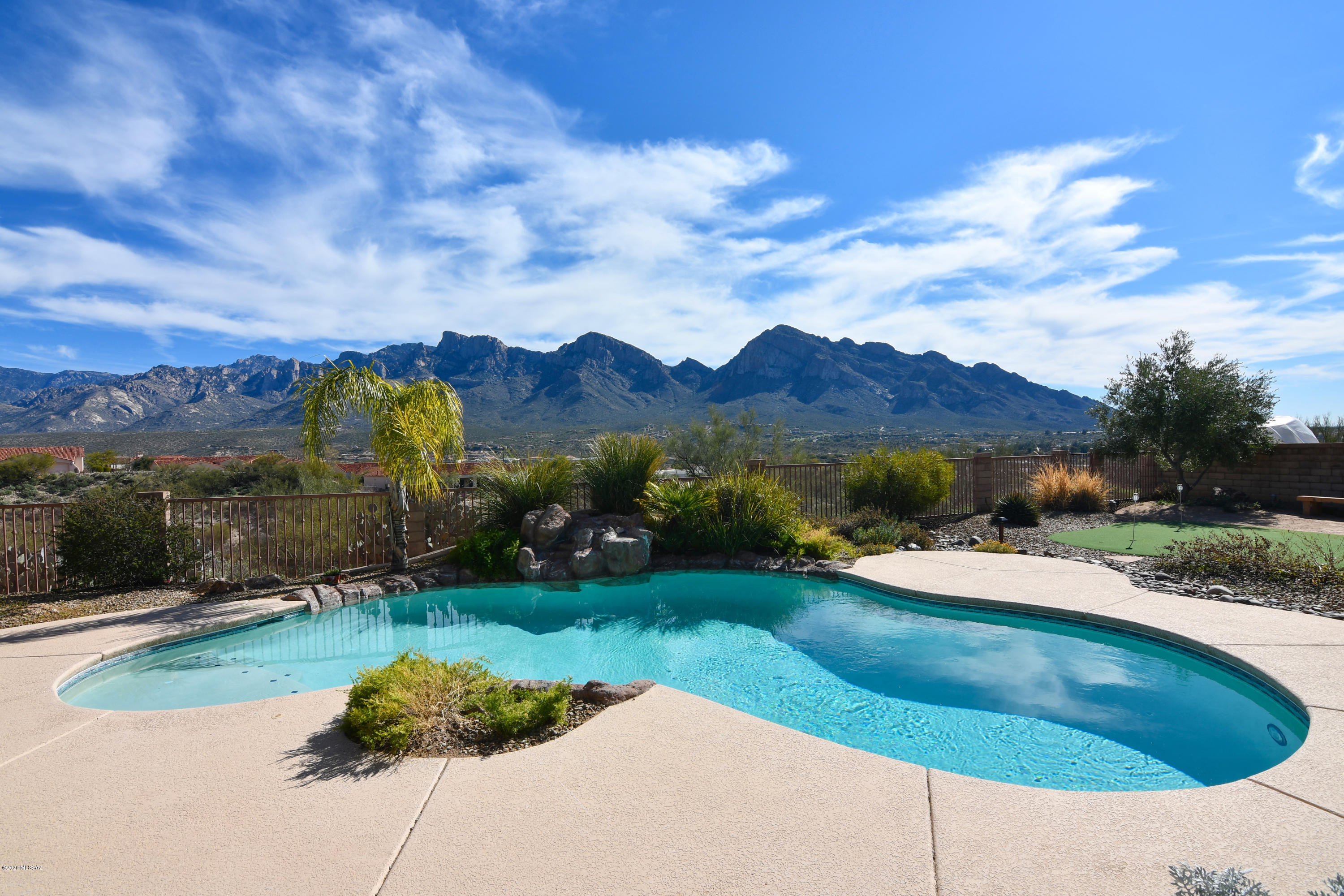Sweeping Catalina Mountain Views from Inside & Out of this Gated Pusch Ridge Home on an Extremely Private & Peaceful Lot Backing to Open Space. Kitchen with Slab Granite Counters, Stainless Appliances, 5-Burner Gas Cooktop & Center Island. Family Room with Picture Windows Capturing the View & Inviting Fireplace. Living & Dining Rooms for Entertaining. Master Suite with Views, 2 Walk-in Closets & Private Porch. Master Bath with Garden Tub, Walk-in Shower & Double Sink Vanity. Architectural Details Include Solid Alder Cabinets & Doors, Impressive Beams & Wood Planked Ceilings. Den, 3 Full Baths & Laundry Room. Resort Quality Outdoor Living Space with Pool, Porch, Extended Flagstone Patios, Outdoor Kitchen, Kiva Fireplace, Putting Green & Amazing Views.