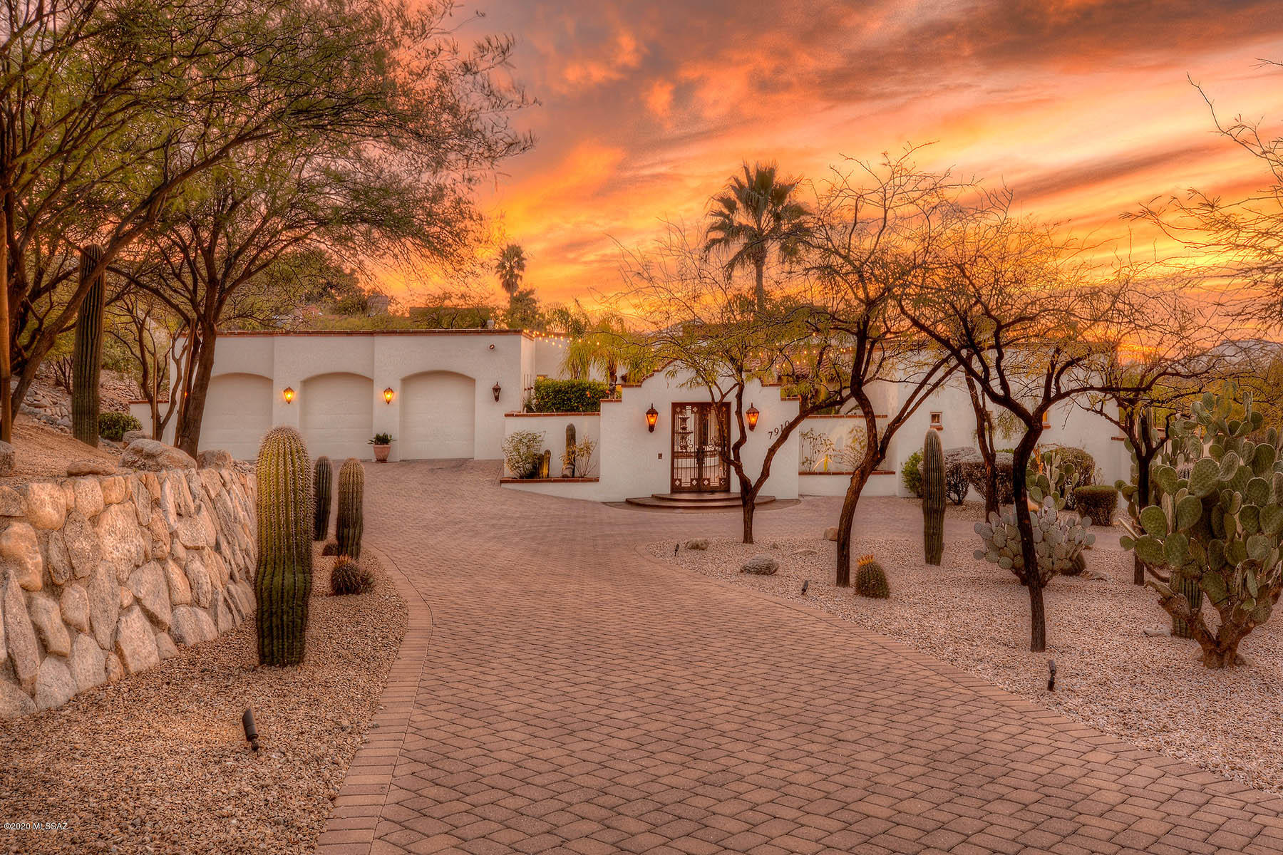 Exceptional Spanish Colonial Masonry home. Enter thru arched entryway to a lavish courtyard w/Cantera Stone fountain, palm & banana trees, that offers an atmosphere resplendent of ''old world charm'' of the desert SW.Concrete flrs thruout,wood beamed ceilings,built-ins,niches,Mexican tile are a few of the elements that enhance this wonderful home. Grand livingrm w/FP. 5 bedrms, 4 w/a bath en-suite + a 1/2 bath for guests. Mstr bedrm has a FP, private courtyard, Mstr bathrm is beautifully appointed w/stone surrounds, walk-in closet. Gourmet's kitchen w/granite counters, SS appliances & ample storage.  Incredible backyard w/ covered patio, spa, pool, putting green & Ramada w/a full kitchen. Extra large immaculate 3 car garage w/storage. Belgarde brick driveway. All sited on 1.13 acre lot