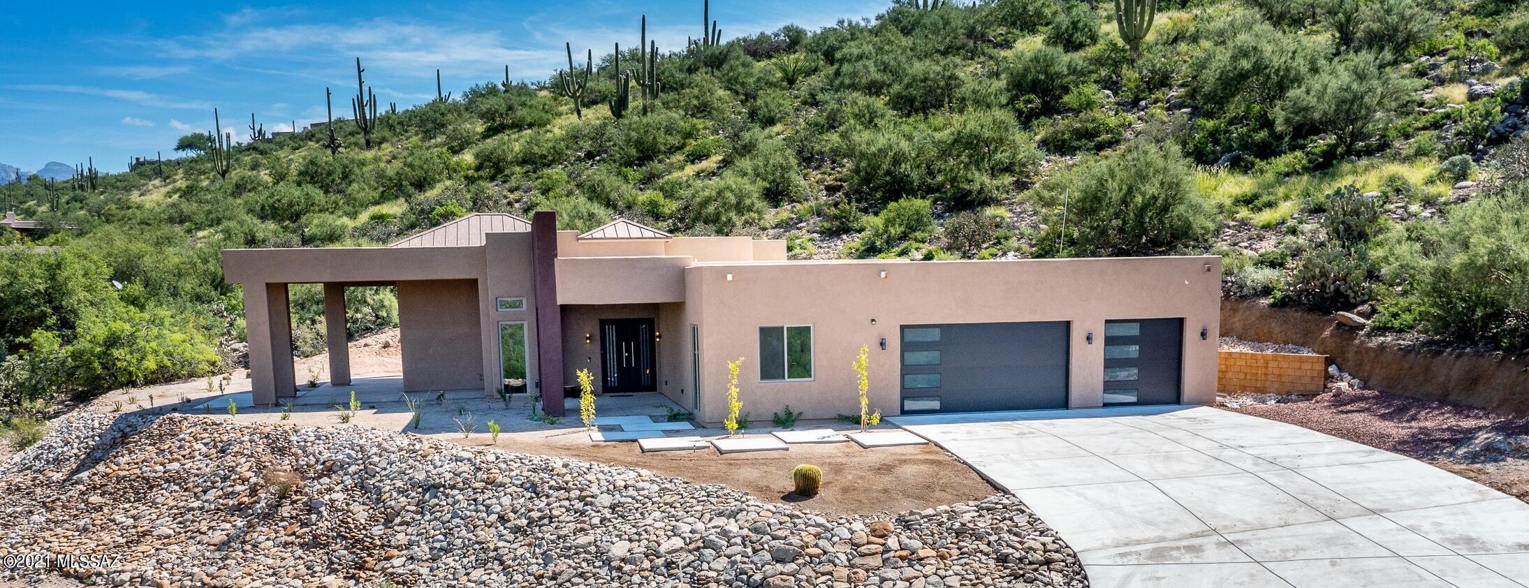 PRICE REDUCED ON THIS STUNNING MUST SEE Foothills Contemporary new build!! Amazing mountain views, 16', 14' & 10' ceilings; Designer touches galore. 3 bedrooms, 3.5 baths, plus an office & a game room. Enter through the custom Metal front door; then see your Chef's kitchen w sleek Espresso cabs, SS appliances, & a beautiful Quartz island w breakfast seating. The Bar area includes wine chiller & beverage fridge.  Huge view windows along West elevation provide incredible Catalina Mtn views from Glass walls at Great rm, Dining, Game rm & Master Suite.  Features include a 2-way Fireplace from Great room to Master suite; a Jacuzzi tub and MORE! See Photos for FLOOR PLAN. Qualified Buyers Only. Seller/Agent related. For showing appt or questions contact Listing Agent.