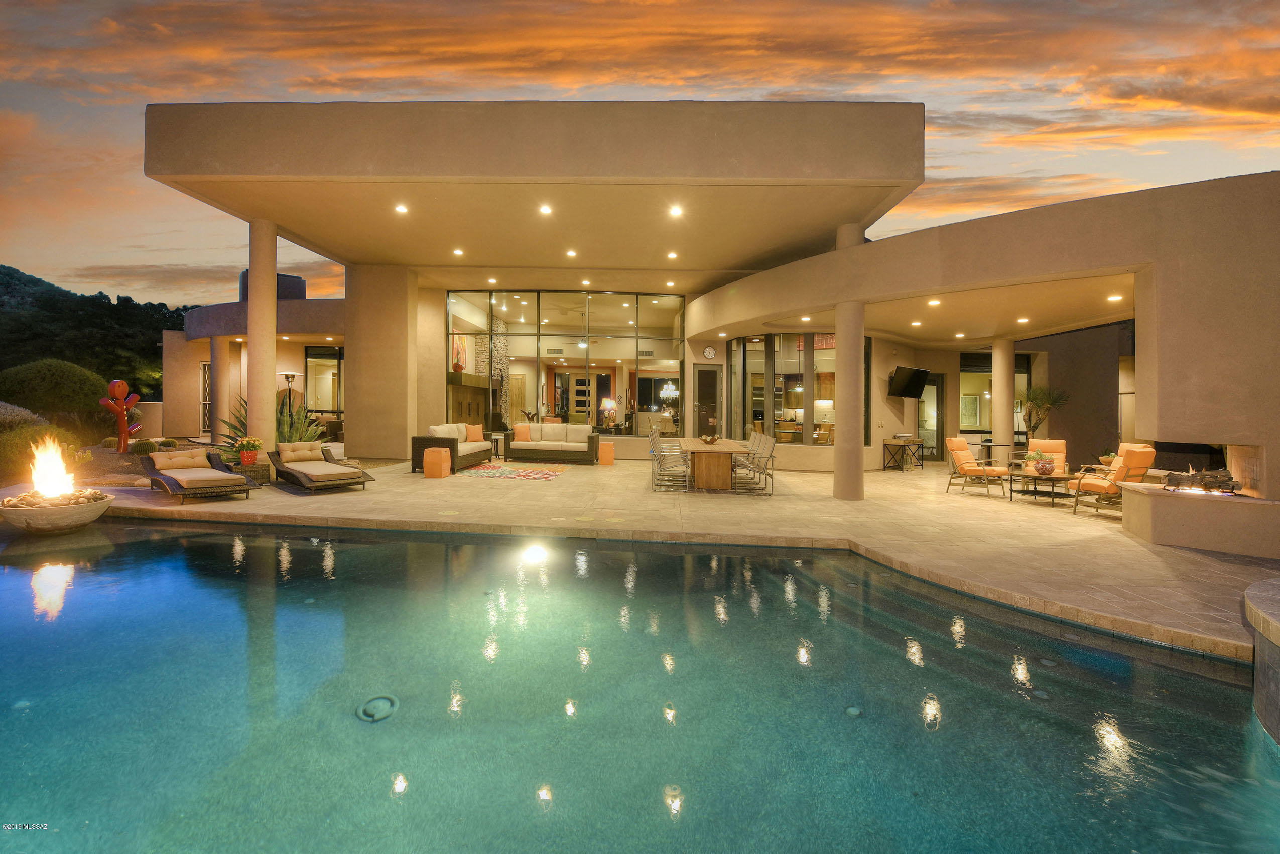 *FIRE & ICE* STUNNING SW CONTEMP NESTLED IN GATED CANYON PASS! FABULOUS ''DESERT'' SETTING BRINGS THE OUTDOORS IN...WALLS OF GLASS FILL THE GATHERING RM W/INCREDIBLE MTN RANGE TO ENJOY! OUTDOOR LIVING AT ITS BEST... SPARKLING/SOLAR HEATED POOL/SPA, TONS OF PAVED PATIOS/+EXT'D PORCH, ALFRESCO DINING/COOKING, COZY FP,  DRAMATIC FIRE/WATER BOWLS!! EXQUISITE DESIGN & APPOINTMENTS!  GREAT RM OFFERS FLOOR/TO CEILING GLASS, ELEGANT STACKED STONE FP, BUILT IN MEDIA CABINETS, BAR- PERFECT FOR ENTERTAINING! DREAM KIT- QUALITY CABS W/EBONY GRANITE  & PEWTER GLASS TILE BKSPLASH, HUGE ISLAND, SS APPLIC-DBL OVENS/WARMING DRAWER, CASUAL DINING AREA ! GUEST WING OFFERS 2BR/2BTH ENSUITE, MSTR RETREAT- COZY SITTING AREA, ROMANTIC FP, SPA TUB & WALK IN SHOWER, HIS/HER CLOSETS!  *SOME FURNISHINGS ARE FOR SALE