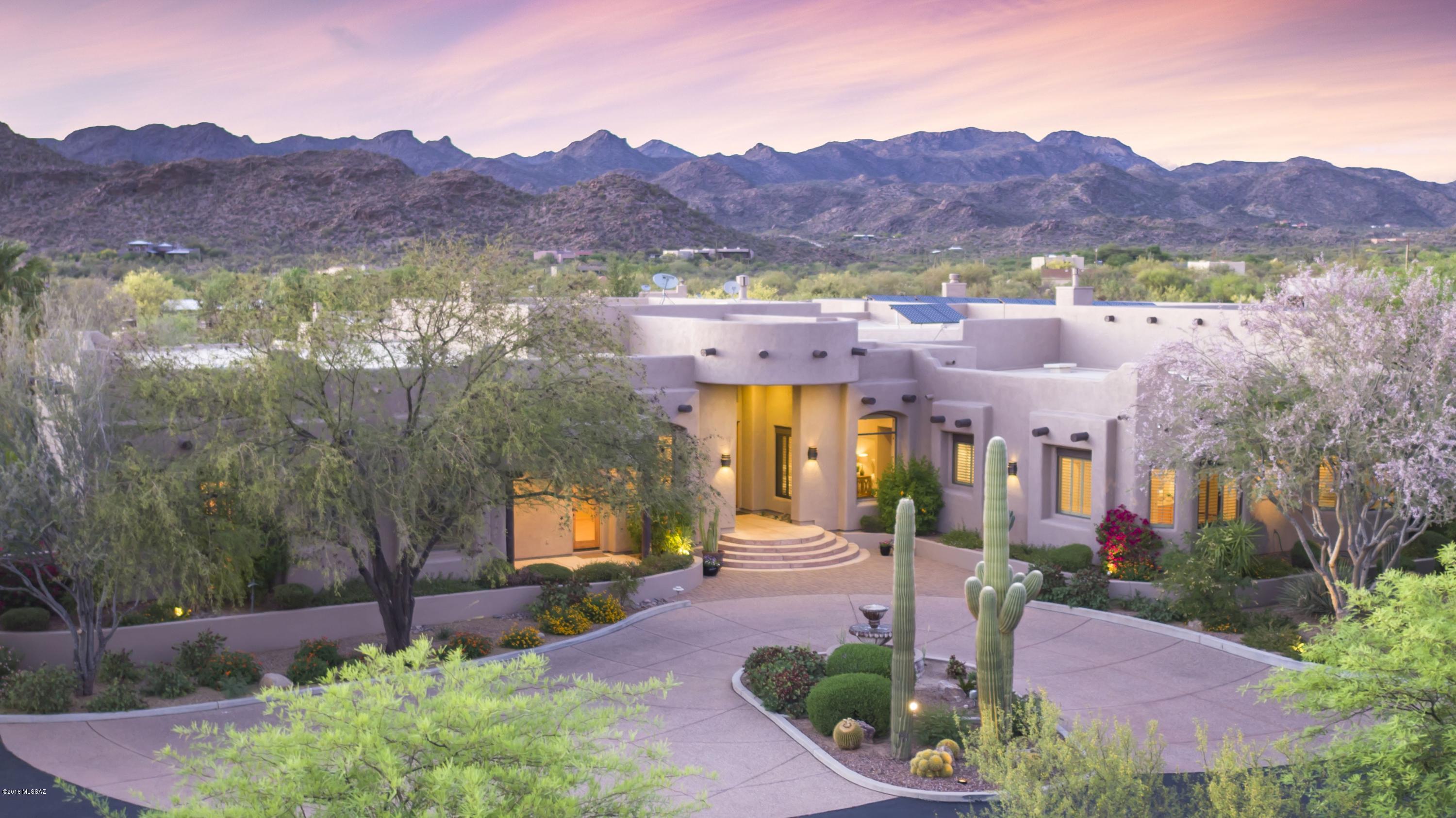5,974sf 4BR/4½BA southwest style retreat on 4+ acres in gated enclave of 8 homes offering privacy w/living room, dining area, family room, large kitchen w/breakfast bar & casual dining, den, rec room, exercise room + 949sf 2BR/1BA guest house w/fireplace & large covered patio, pool/spa+5,075sf sports bar/garage for 15 cars+storage. Great room has wall water feature & fireplace. Kitchen has teppan-style grill, built-in wok, stainless appliances, granite counters. Family room off kitchen has fireplace. Travertine tile, large windows, vaulted ceilings. Spacious master suite has fireplace, huge walk-in closet & luxurious bath. Fenced backyard w/fireplace, Built-in BBQ, pool/spa. Secluded yet minutes from Dove Mountain & Oro Valley  golf, shopping & restaurants. https://youtu.be/k8Q_wqygsQY Solar PV system installed, significantly reducing monthly utility payment to TRICO.