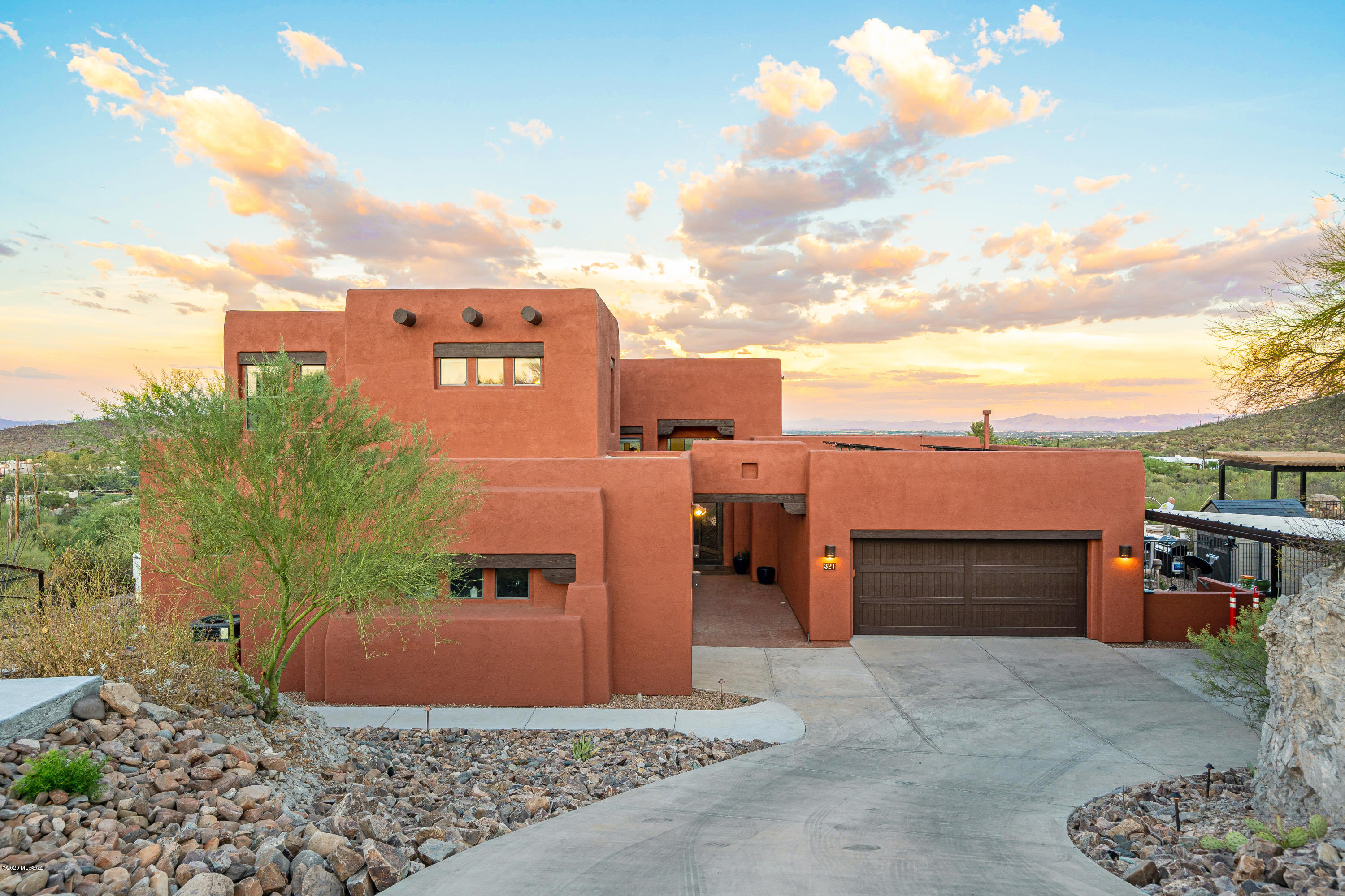 Stunning 5 bed, 4 bath, hill-top home on Tucson's west side. Spacious 3.38 acre private lot with impressive mountain and city views. An entertainer's dream, with 5 covered parking spots, an additional 3-car slab and hand-railed walkway for guests. Walls of windows bring the outside in with spectacular views of A-mountain, Catalina and Rincons. Spacious, well appointed kitchen with 6 burner gas stove, double ovens and commercial fridge/ freezer combo make dinner parties a breeze. Family and friends will enjoy the private guest quarters w/bath upstairs. Outdoor oasis includes heated negative edge pool and spa with waterfall. So relaxing. Huge covered patio, outdoor bar and Pergola offer an escape from the mid-day sun and expand your space for entertaining,. Roof-top solar = low cost energy.