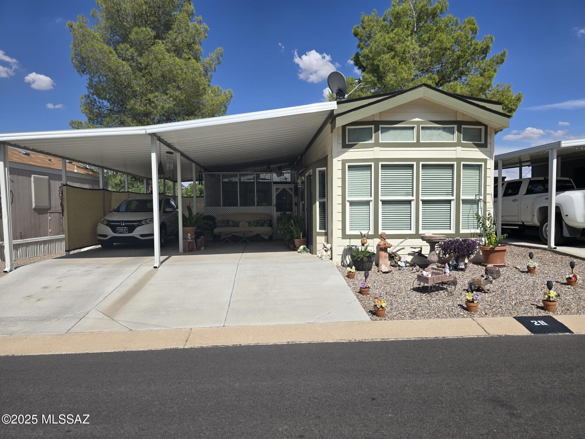 ABSOLUTELY ADORABLE!  This immaculate one bedroom, one bath Park Model, includes, a screened in porch and shed with washer and dryer, plus covered parking, and low care Landscaped yard.  Community offers Clubhouse with fitness room, laundry room, Pool table, TV area, Party area, AND Pool, Spa and small observatory.   Pickleball court and dog park too.  All this, and more!  Conveniently located close to shopping, medical services, restaurants, library, etc.   Partially furnished, and furniture negotiable by separate Bill of Sale. 
Price is for home, and lot rent is $385.94                 per month and adjusts seasonally.  Buyer must apply to Butterfield RV Resort to rent lot. This is lease hold Park Model in RV resort. Lot rent varies per season. Currently $395.83 per month.