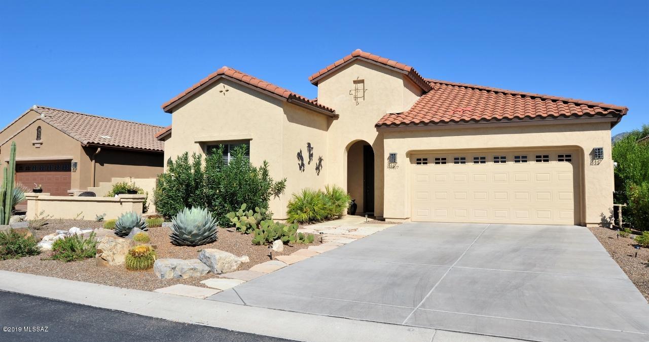 DON'T MISS THE 360 WALK-THROUGH VIRTUAL TOUR ATTACHED (Under Photos)! This Strada model has an open floorplan with a gourmet kitchen featuring granite countertops, a tasteful backsplash, large island, beautifully stained cabinets, desk area, stainless steel appliances and a formal dining room. The split bedroom layout offers a spacious master suite with a large walk-in shower and closet. The private guest bedroom has an EN-SUITE FULL BATHROOM-Perfect for visitors! Spacious den makes a great office or craft room. Relax on your large covered patio and enjoy your own private backyard oasis which includes a vegetable garden and tons of citrus trees including grapefruit, lemon, lime and orange trees! Enjoy the resort style living here at Saddlebrooke! Make this beautiful house, your new home.
