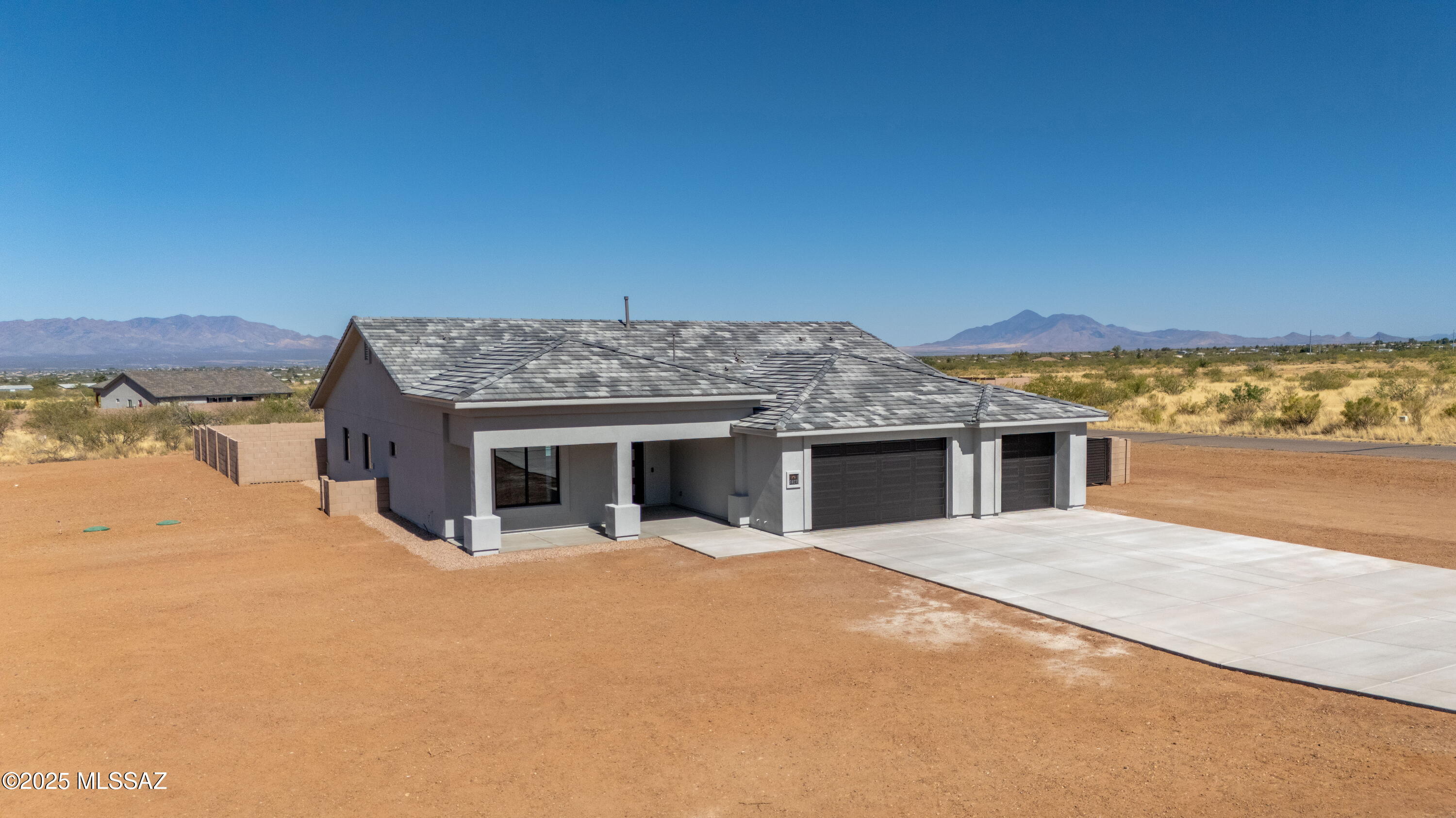 Custom Sun Canyon Home in the Ranchos San Pedro subdivision. 4 bedrooms, 3 baths and 3 car finished garage with epoxy floor finish . 10' ceiling at great room and dining area with 16' sliding glass door to patio. Kitchen includes group D quartz countertops, double ovens, stainless appliances, gunmetal black undermount kitchen sink, upgraded black window frames throughout the house, full overlay cabinets with crown molding white & limeston colors. Tile flooring throughout, block wall around swimming pool. Corner lot on a cul-de-sac. Covered porch with mountain views of the Huachuca mountains and covered patio with views of the Mule & Dragoon mountains. Construction features-2x6 exterior framing,Polyglass premium roof underlayment, R-21 Open-cell foam exterior walls,Tyvek wrap vapor barrier