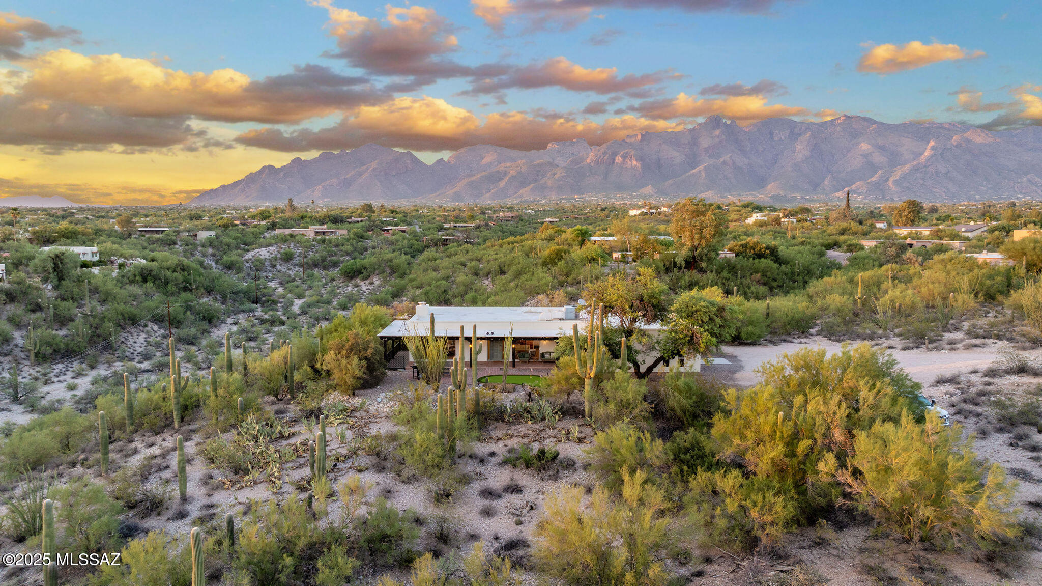 🌵 Desert Charm Meets Modern Luxury in North Tucson 🌄 Amazing opportunity to own your slice of private Sonoran paradise! Nestled in a quiet pocket of the Catalina Foothills, providing breathtaking unobstructed panoramic Catalina mountain and sweeping city skyline views, this beautifully remodeled, turnkey single story, no stairs/no steps 2,173 SqFt 2 bed/2 full bath with attached 606 SqFt 2 car finished garage blends the timeless charm of a southwestern ranch with the comfort and convenience of modern amenities. Located on a premium 8.37 acre CR-1 splittable private lot, no HOA, this unsubdivided horse property offers the privacy, seclusion and freedom you've been craving with endless possibilities for expansion.
Featuring N/S orientation, private driveway located at end of low traffic road, easy maintenance yard surrounded by hundreds of Saguaro cacti, putting green, barbecue, 693 SqFt of covered patios including North facing patio, wrap around deck and front covered extended patio providing epic unforgettable Tucson sunsets. Step inside the completely remodeled home featuring: all furniture included with acceptable offer, luxury plank floor and tile throughout (no carpet), painted textured ceilings (no popcorn), multiple picture windows along with 4X sliders provide omnipresent mountain views and fantastic natural light, copper plumbing, gas HVAC with digital thermostat, modern lighting including 24 additional canned recessed lights, matted brushed gold hardware, formal dining area with original stacked stone wood burning fireplace, and spacious living room with built in butcher block modern bar vanity with slider out to private covered deck. Separate family room located adjacent to entertainer's dream kitchen with full slab quartz counter tops, bar seating, matching white Café luxury appliances including 6 burner gas double oven, dishwasher and refrigerator, tile backsplash, hanging metal exhaust hood, designer grade white modern kitchen cabinets with soft closing drawers, two closet pantries and direct access to attached garage. Retreat to the spacious primary bedroom for more Catalina mountain views, dual closets, remodeled ensuite bathroom featuring designer tile flooring, full slab quartz dual sink modern vanity, and grand walk-in tiled glass shower with ceiling mounted rain shower.
Convenient Tucson Foothills location minutes from St. Phillp's Plaza, shopping, The Union, Sullivan's Steakhouse and other fine dining restaurants, minutes away from La Encantada, Rillito Race Park, Chuck Huckelberry Loop (a 131-mile network of paved shared-use paths), Tucson Mall, Trader Joes and so much more! Whether you are a local Tucsonan or a seasonal visitor looking for a turnkey move in ready retreat, call to make your appointment to view this unique property today!