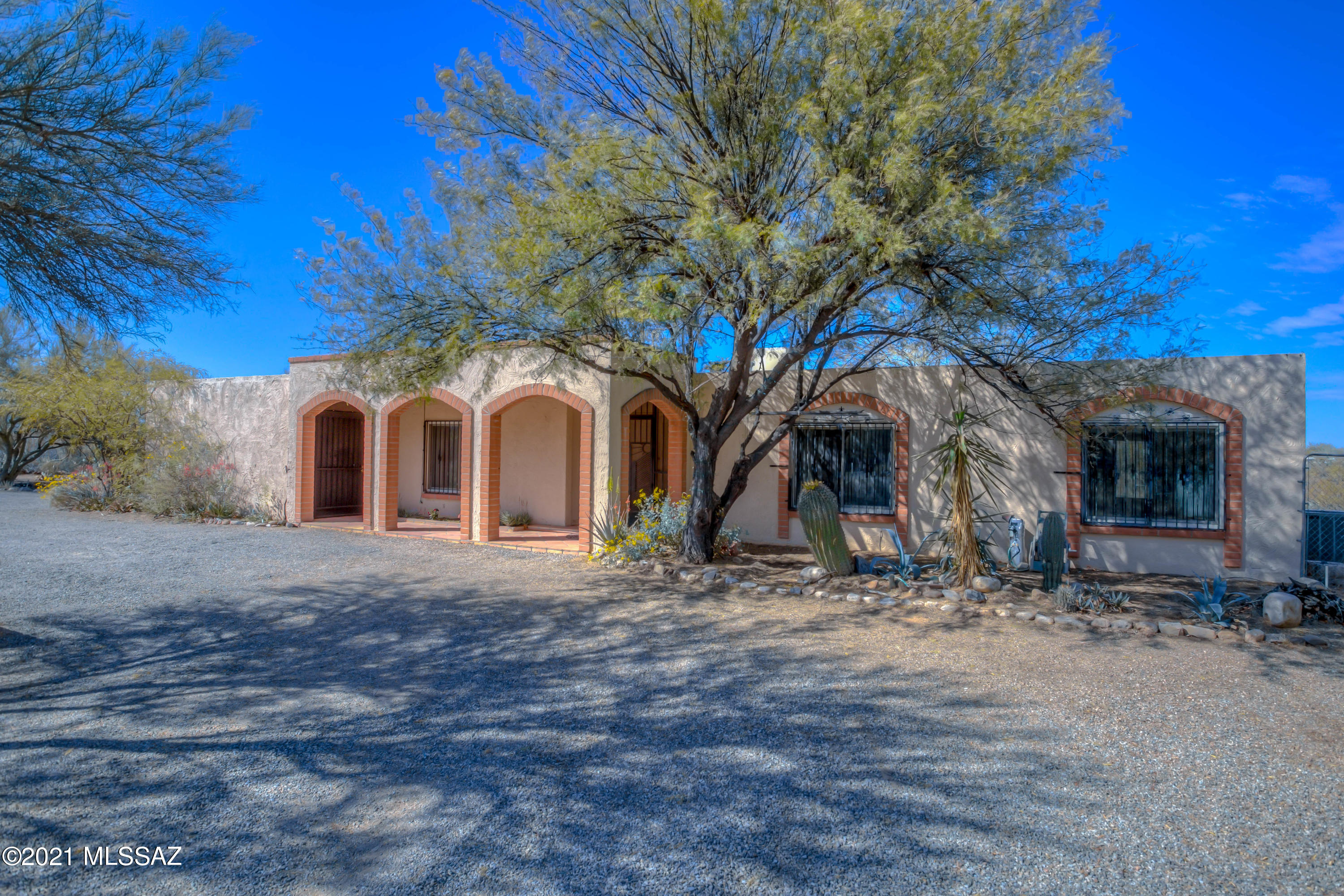 WELCOME to this beautiful Tucson Classic on a PRIVATE .83 Acre Lot!  This inviting home features 1,477 sq.ft., 3 bedrooms w/generous closets, 2 baths, Formal Living Room, Dining Room, Family Room w/cozy Fireplace, & a bright Kitchen w/granite countertops! Complete with a refrigerator, electric stove, washer, gas dryer and window coverings, this home is truly move-in ready!  Updated with high quality, newer Anderson windows, newer central A/C and a well-maintained roof.  The oversized, attached garage includes a large storage/workshop area!  Venture out back to a spacious covered patio with sunshades, automatic drip system, view fencing and serene landscaping!  Enjoy endless natural space and privacy on this huge lot!  Close to shopping, dining, trails, medical and schools! 3D Walkthru!
