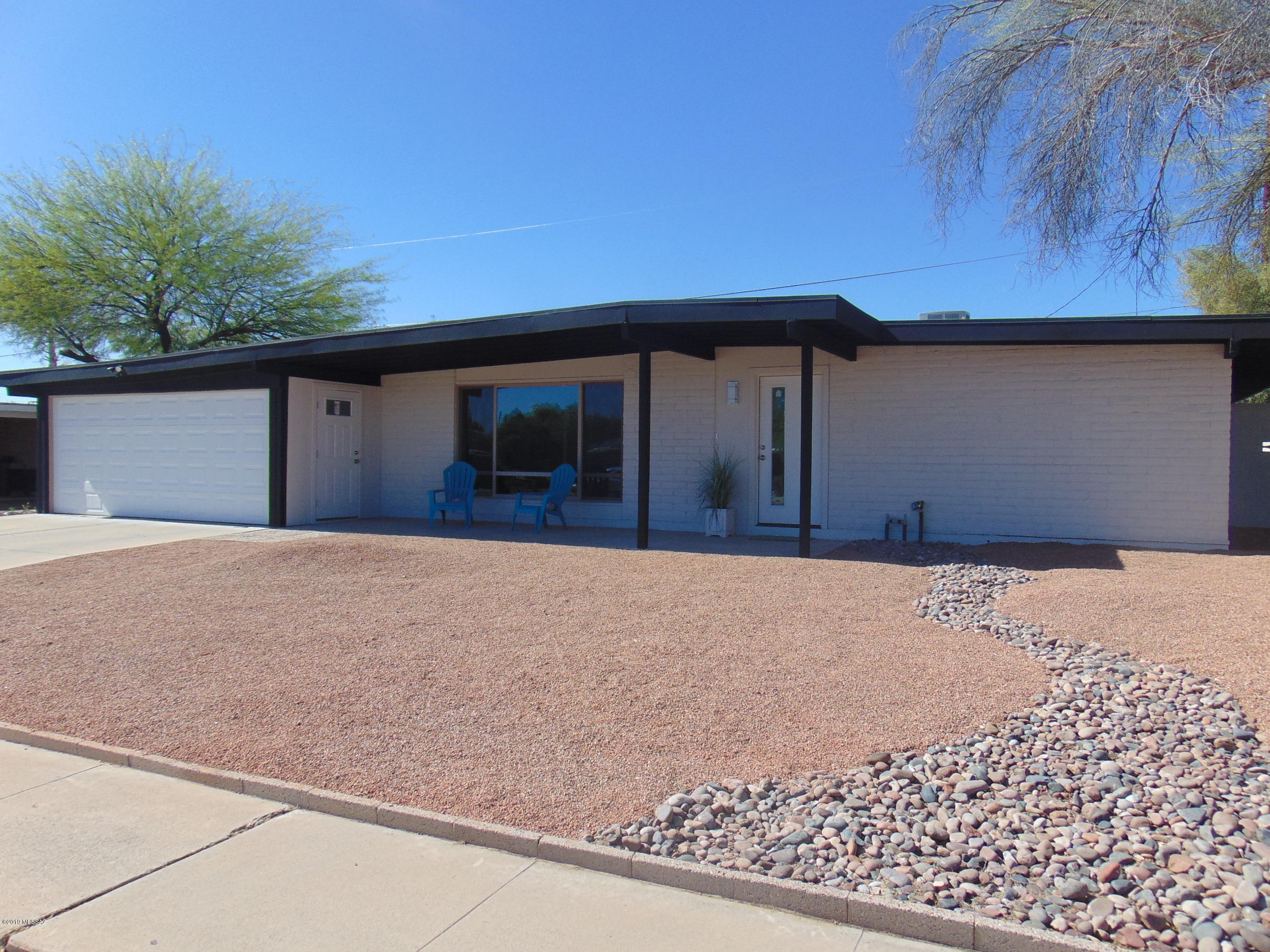 This GORGEOUS home has been COMPLETELY remodeled with the finest of finishes! Bamboo flooring! Oversized Tile! Madison Doors! Dual Pain Windows! HVAC!  Wood Tile Cover Patio! Full Custom Landscaping!  COMPLETELY.   Perfect floor plan encompasses four spacious bedrooms, two luxurious bathrooms, an open kitchen and a great room designed to entertain your family and friends. Quartz counter top with island breakfast bar, Carrera Marble back splash, new stainless appliances.  Two car garage with attached storage galore!   Enjoy the beautiful Catalina Mountain views from your open concept living space. Nicest home in  highly desirable east side neighborhood.