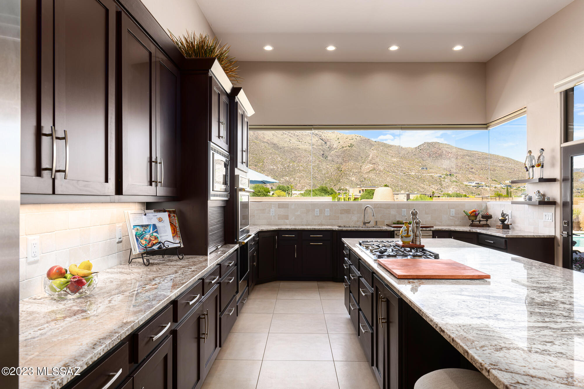 Panoramic Catalina Mtn views and fabulous setting in Catalina Foothills Alta Vista neighborhood! Stunningly executed contemporary design with huge windows and elegant luxury. Beautifully remodeled and updated 4,434 SF residence with 4BR, 3BA, Office and Rec Room will take your breath away! From the terrific curb appeal on an elevated corner site with large and private front courtyard to the WOW factor upon entering the foyer and bright open great room with striking views, gorgeous fireplace wall, inviting wet bar, and totally awesome kitchen. NO STEPS! Walled yard for private relaxation: pool, spa, built-in BBQ, multiple dining & sitting spaces! LED lighting, auto shades, 4 Fpls, tile & eng'd wood flooring, custom master closet, 3-car garage w/epoxy floor & cabinets. Move-In Ready Perfect
