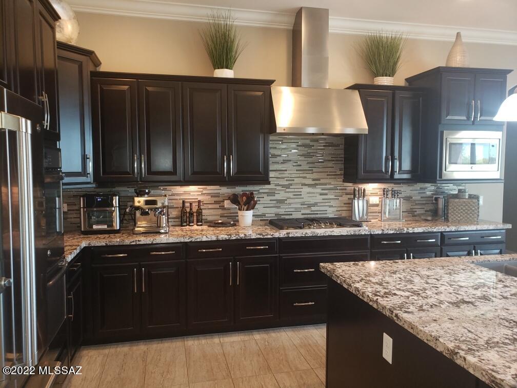 This exquisitely decorated home with all the finest upgrades is located in the highly sought after Tortolita Vistas Subdivision. All homes in this neighborhood are single story and sit on .75+ acres. This beautiful home backs up to natural desert. Enjoy the large pool in a very private setting with views of the Tortolita Mountains and sunsets. The office has a spacious custom built-in desk, beautiful tile throughout, granite, backsplash and custom interior paint.