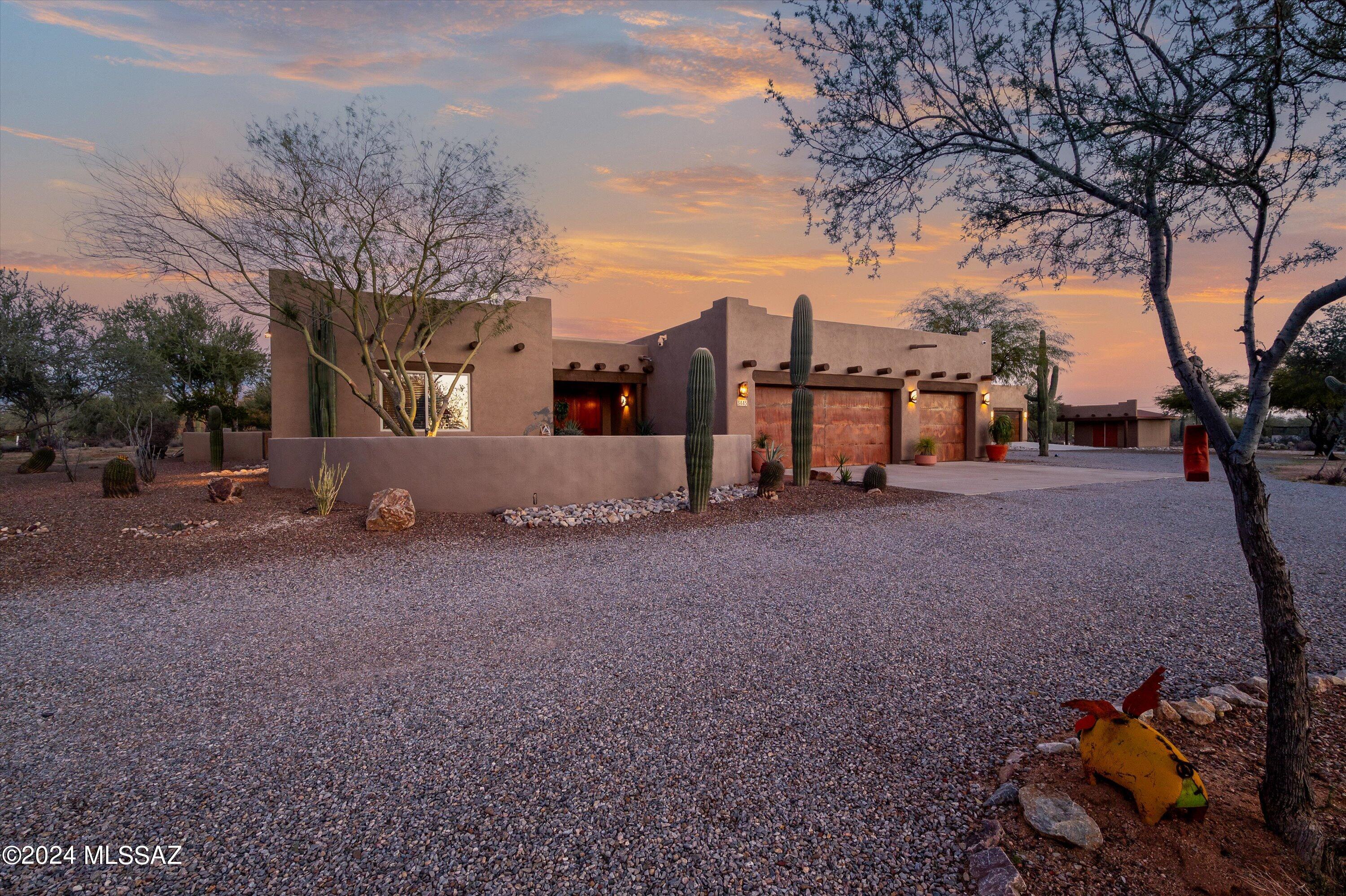 Desert Retreat Awaits You! This beautiful custom home & guest home are perfectly situated on 3.33 acres of impressive desert landscape that has been thoughtfully designed to create your own slice of heaven. Inside the main house you'll find an amazing  split floor plan with large bedrooms and an impressive primary suite. The high ceilings, exposed beams, rich custom doors, cabinetry, and top notch finishes throughout make this the place to call home. Step outside and take a moment to soak up the beautiful resort style backyard with a sparkling pool, built in barbecue grill, separate fire pits, gazebo bar, turf and so much more. Wait till you see the guest house & views! Location Location! Zoned for horses with xl garages, separate storage, and plenty of space to make that reality.