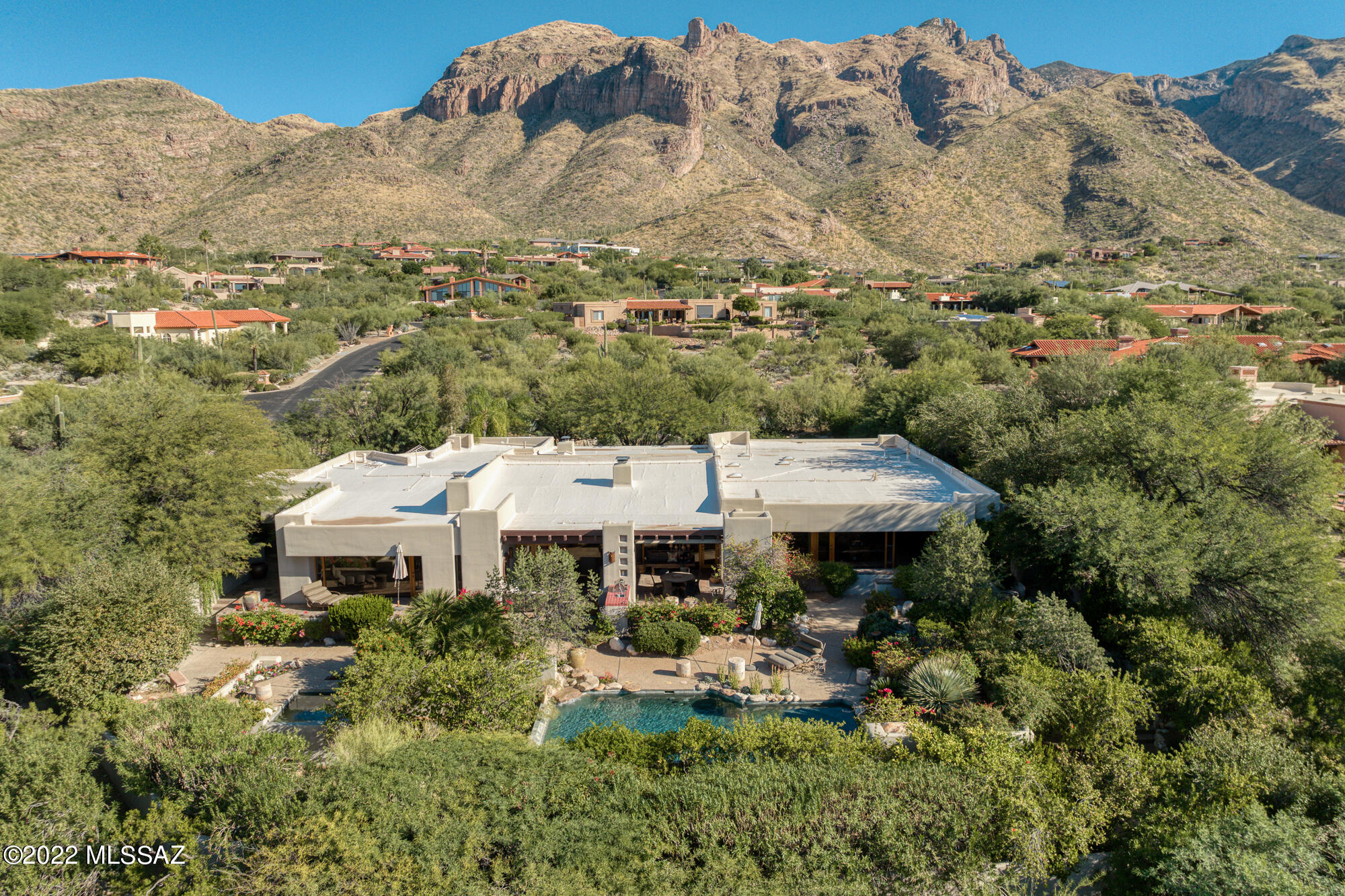 The perfect blend of modern architecture & natural warmth, this Tyson/Murphy design offers panoramic city/mountain views, A+ location & every conceivable amenity available to the discerning Buyer. The centerpiece of this architectural jewel is showcased in walls of glass overlooking lush vegetation, pool/spa & stunning city views. 
Envision entertaining on a grand scale in enormous LR  adjoining DR w/double FP  Every amenity of comfort & style is here from front courtyard w/water feature, unobstructed Catalina Mtn. views,  resort-like backyard, gym, & 2 primary suites. Primary suite 1 offers  total privacy w/FP, private door to patio leading to spa in parklike setting.  With multiple outdoor spaces the home is ideal for al fresco dining & entertaining!  Truly the epitome of luxury & style