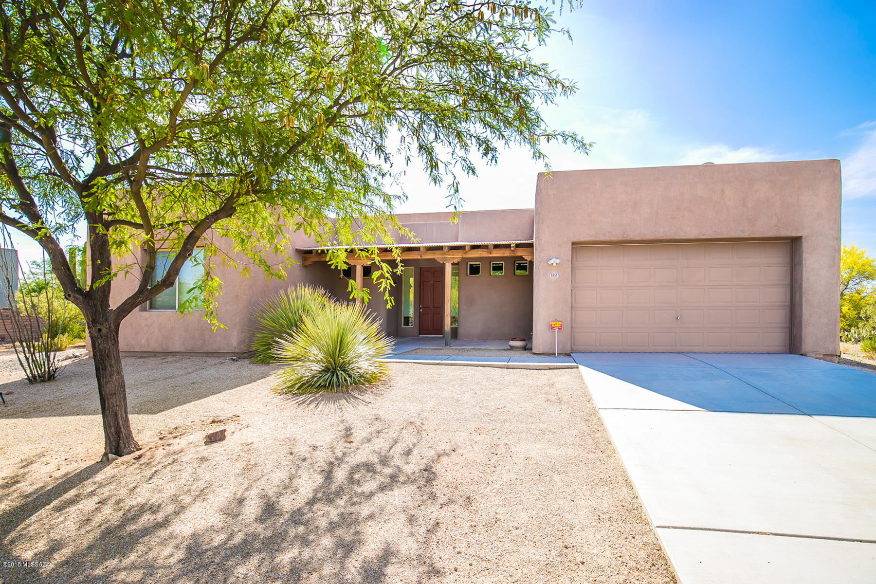 Beautiful 3BR w/Den T.J. Bednar built Santa Fe on over an acre. This beautiful home features soaring ceilings w/hand hewn vega beams. Great room off of open kitchen w/breakfast bar. Split bedroom plan ideal floor plan w/Master Suite, w/walk in closet & large bath & 2 guest bedrooms, full bath on opposite side of home. Custom wood touches & trim throughout, hand carved shutters, & built in shelves in study/Br. This private desert lot is amazing, step out to the back covered walled in & paved patio that is perfect for entertaining & relaxing. Enjoy mountain view, dark sky viewing at night & the privacy an acre lot can provide. No HOA.
