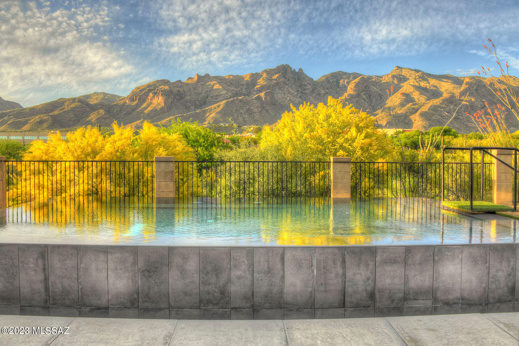 Sited on one of the most premier lots in the exclusive gated/guarded Villages of La Paloma,& host to breathtaking, unobstructed panoramic views of the Catalina Mountains, Finger Rock & the Jack Nicklaus-designed signature golf course! Resort-style back yard features a brand-new STUNNING elevated infinity pool, jacuzzi, ez care artificial turf, extensive patios & shaded porch for fabulous Arizona outdoor entertaining. All new windows throughout & gracious interiors that include cathedral ceilings, open Great Room plan w/walls of view windows, beautifully appointed kitchen w/newer appliances & eat-in breakfast nook. Custom light fixtures & window coverings in a terrific split plan that has the primary on the lower level with pool access, luxe dual sink bath & walk in closet. Spectacular!