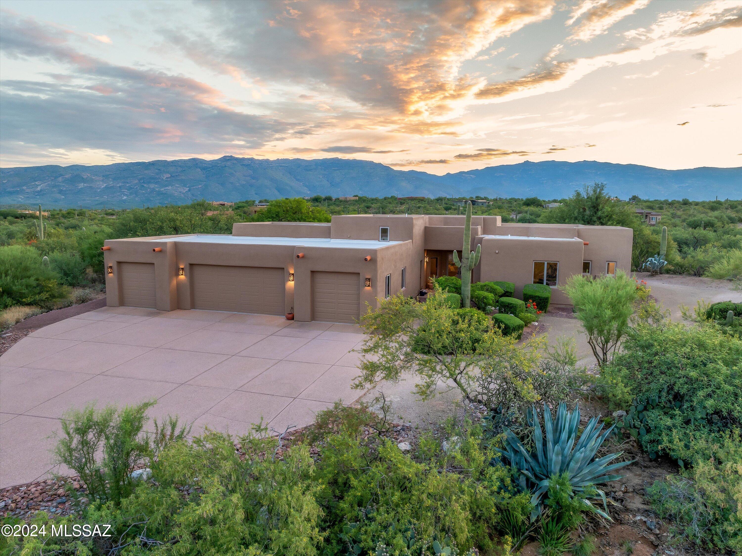 .Welcome to your dream home nestled in the serene beauty of Coyote Creek.  This exquisite 3-bedroom, 3-bathroom custom residence boasts 2,709 square feet of luxurious living space, set against 2.13 acres of breathtaking desert landscape.  Complete w/ a 4-car oversized garage! This home boasts 2 primary suites, each w/ their own ensuite.  Gourmet Kitchen w/ top-of-the-line appliances, granite countertops, and Knotty Adler cabinetry that adds a touch of rustic elegance. The open floor plan seamlessly blends the kitchen, dining, & living areas, creating a perfect flow. Spectacular mountain vistas from almost every room! The meticulously designed backyard offers an oasis of greenery, perfect for relaxation or outdoor entertainment.  A perfect blend of luxury, functionality, & natural beauty! Updates include: Newer HVAC systems and heat pumps.  Dual system. Newer water heater, new interior paint, roof recoated, carpet updated also.  House has been METICULOUSLY maintained!!
Elegant Finishes throughout: Beautiful travertine floors and stylish bathroom surfaces enhance the home's timeless appeal and ensure lasting beauty.
Unique Attic Feature: A rare find, the 12x12 attic above the laundry room provides extra storage accessible with a pull-down ladder.
Well-Equipped Laundry Room: Features a sink, abundant cabinets, and counters, making laundry chores a breeze.
Upgraded Anderson Windows: Revel in the beauty of Anderson windows, which are complemented by exquisite wood trim, offering both energy efficiency and an elegant aesthetic.
Knotty Adler Details: Throughout the home, Knotty Adler cabinetry and doors provide a unique and stylish touch, complementing the custom design and adding character to every room.
Outdoor Recreation: Enjoy extensive walking and biking trails that wind through the picturesque desert landscape, perfect for outdoor enthusiasts.
Equestrian Center: Experience the joys of horseback riding at the nearby equestrian center, complete with boarding facilities.
Sports Facilities: Stay active with access to basketball, pickleball, tennis, and volleyball courts, all within this vibrant community.
Proximity to Tucson: Just minutes from Tucson, this home offers the tranquility of desert living with the convenience of urban amenities.