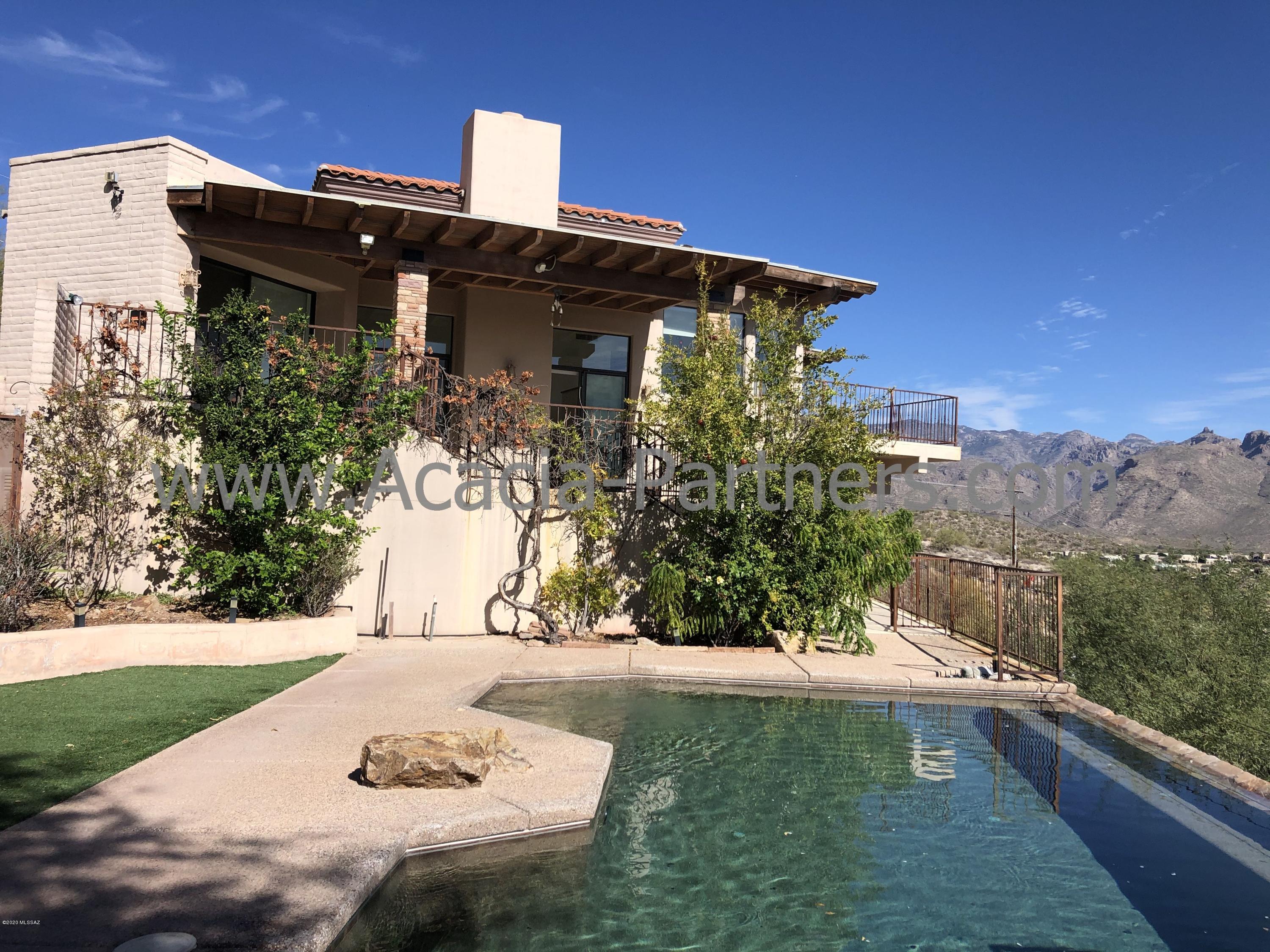 Incredible Views from this Custom Home! This Beautiful Home in the Catalina Foothills has it all! Tile Throughout, Stainless Steel Appliances, Washer/Dryer, Pool, Jacuzzi, Covered Patio and Amazing Views. This is a must see to appreciate all that this home offers. Acacia Partners