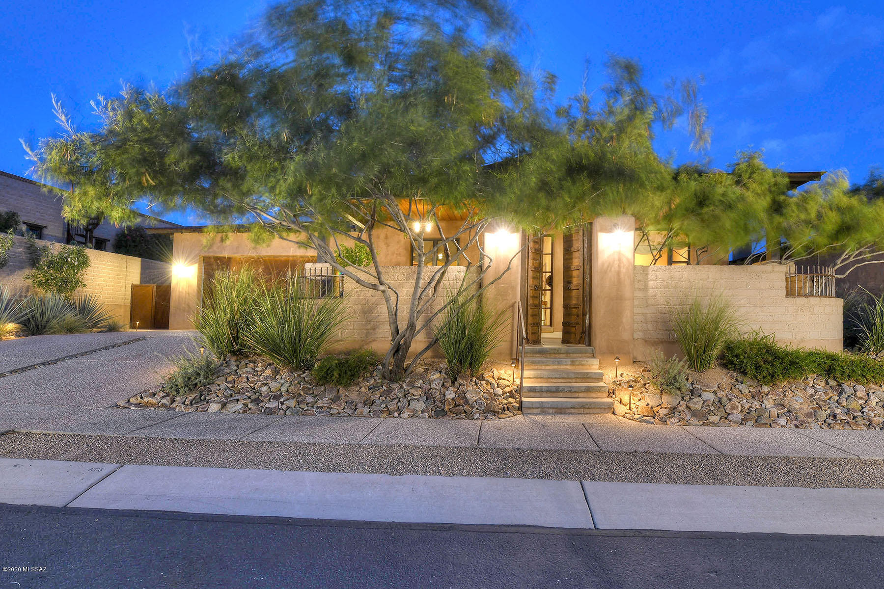 Unsurpassed elegance and exceptional craftsmanship are the hallmarks of this stunning home in gated Sky Ranch. Ready for your most discerning buyers, this timeless masterpiece by James Gray of Stellar Gray Homes features Rastra block (Insulated Concrete Form) construction, a steel roof, hand plastered interior walls, adobe wall accents and polished concrete floors. Luxury finishes include Metropolitan quartz counters and quartzite kitchen island, Silgranit sink, Thermador and DCS appliances, cedar plank ceilings, iron & glass front door, antique interior doors and enhanced lighting. Step outside to find open desert, dramatic mountain views, a relaxing patio, and appealing landscaping complete with fruit trees. See twinkling city lights from the elevated fire pit. Paradise found!