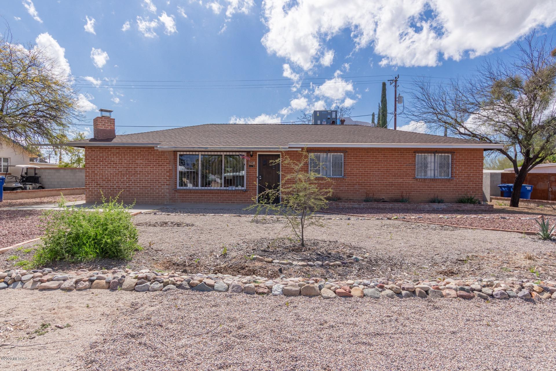 Beautiful 3 bed/2 bath brick home available in the heart of Tucson. Very central location, within easy reach of downtown, the UofA, the I-10 and everything Tucson has to offer. Inside is bright, open and very well maintained with tasteful upgrades and timeless charm from wall to wall. Inviting living area with beautiful wood look flooring and a built in breakfast bar overlooking a the family room with a wood plank vaulted ceiling, rustic wood plank and brick wall features and a charming fireplace. Huge bonus room with plenty of space for a pool table, gaming, crafting, and more. Island kitchen with lots of cabinet and counter space. 3/4 master en-suite. Large backyard with a covered patio and more than enough room for pets, gardening and entertaining.