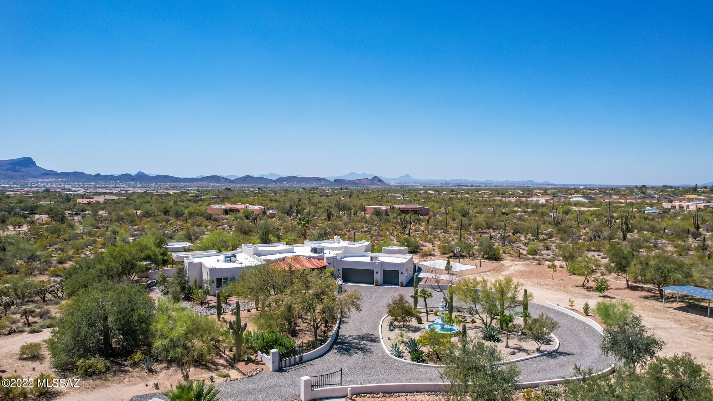 This stunning private oasis on 3.33 acres offers Tucson mountain views, room for horses, RV's and more! Beautifully landscaped, enjoy exquisite outdoor entertaining with pebble TEC pool, built in BBQ, and newly installed turf grass. Plenty of parking spaces with large turn around driveway and oversized 3 car garage. 3988 SQFT home has 13' high ceilings with wood beams and wood trim fill the home with flagstone floors in great room, and large open kitchen with side by side Monogram refrigerator and freezer and quartz counter tops. Spacious primary room has beehive fireplace, and newly remodeled walk in shower and soaking tub. Enjoy a variety of citrus fruits from the orchard, and play ball at the basketball court! Close to shopping and I-10.. This dream home has it all! Owner/Agent