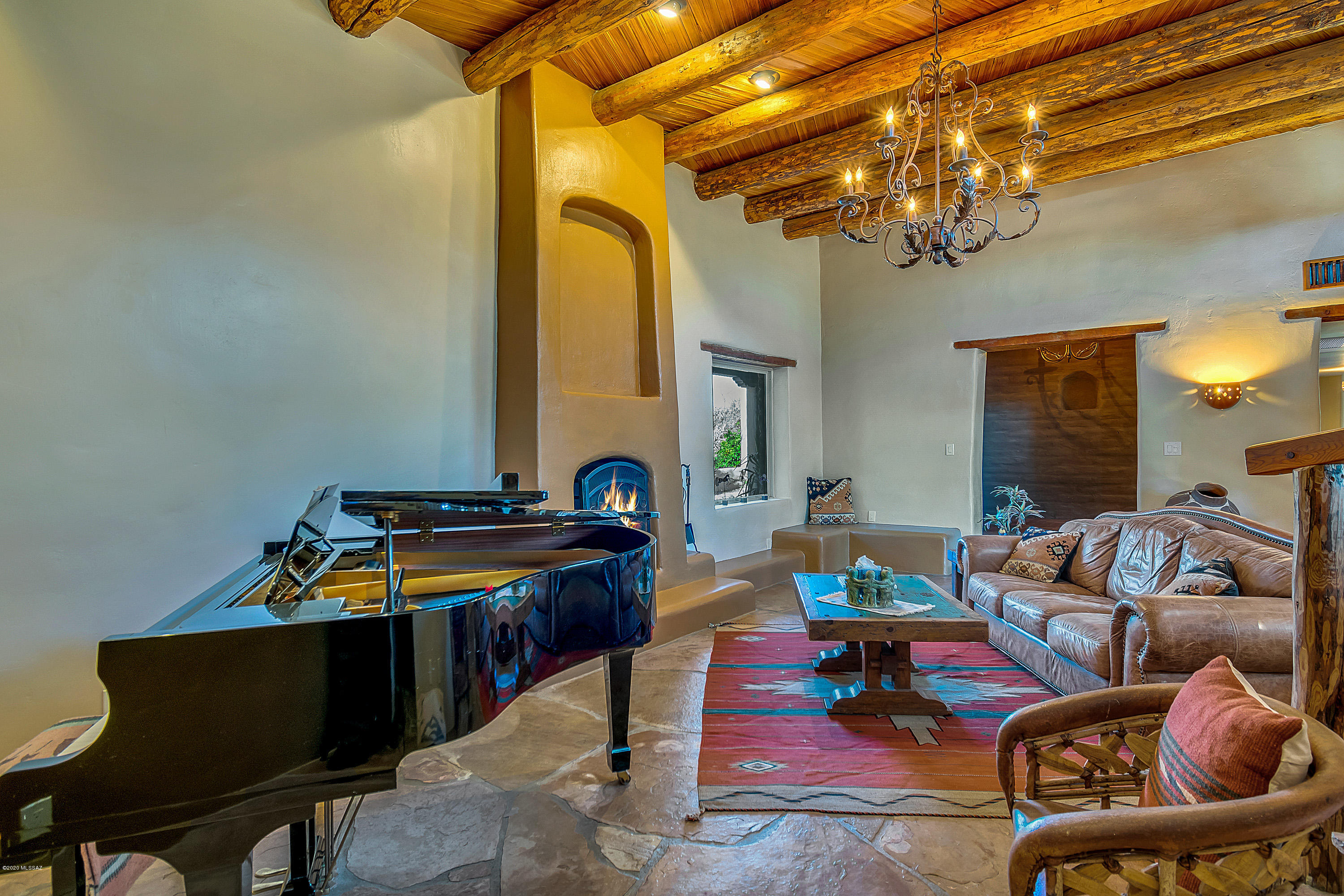 LOOKING FOR A PRIVATE RETREAT SAFE & PRIVATE -The art of Southwest living captured in this home, true to Arizona's rich culture & heritage.  Nestled on private & serene 3+ acres with spectacular Catalina Mountain Views yet 5 minutes to shopping.  Authentic thick exposed mud adobe, stucco and masonry walls with hand-hewn timbers, vigas, corbels and peel posts.  Tall wood laden ceilings,courtyard entry, 4 fireplaces, flagstone & brick floors.  Master private jacuzzi room & couryard patio.  Kitchen with imported lighted Onyx countertops, alder cabinets & stainless appliances. The 6 car garage will be your playhouse.  5 bedrooms plus 4 bath includes guest quarters.  Grotto pool w/swim out to cave with seating .  Horse corral, tack rm, chicken coup & storage.  Don't miss this one! Room to park