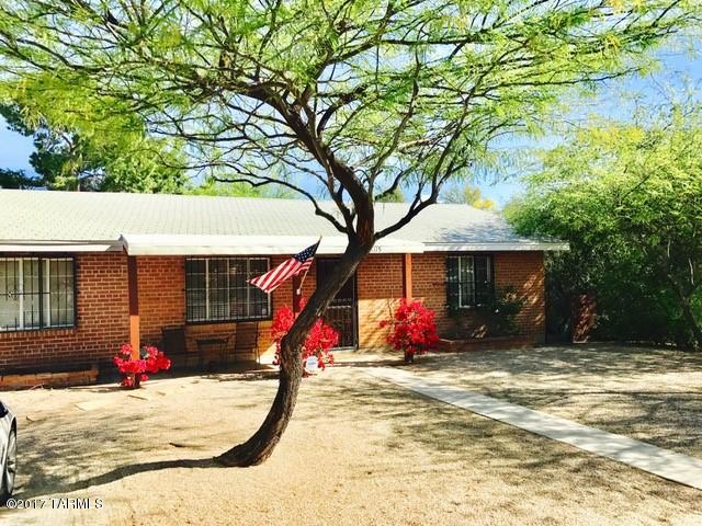 A charming 1950s brick bungalow awaits you; located in the Jefferson Park Historic District just North of the University. Convenient off street parking & covered parking off the alley. Hop on the bike path on Mountain Rd. and you’re just minutes away from the U of A and Banner UMC.  Charming turn-key central home located near the U of A. Fully remodeled kitchen and bathrooms throughout. Kitchen has stainless steel appliances and granite counter tops. Master Bathrooms features beautifully  tiled shower and new vanities. Newer tiled flooring in all areas. Large Backyard  with a carport, storage sheds, mountain views and mature trees.Historic zoning allows for reduced tax rate if you qualify. Not to be missed!