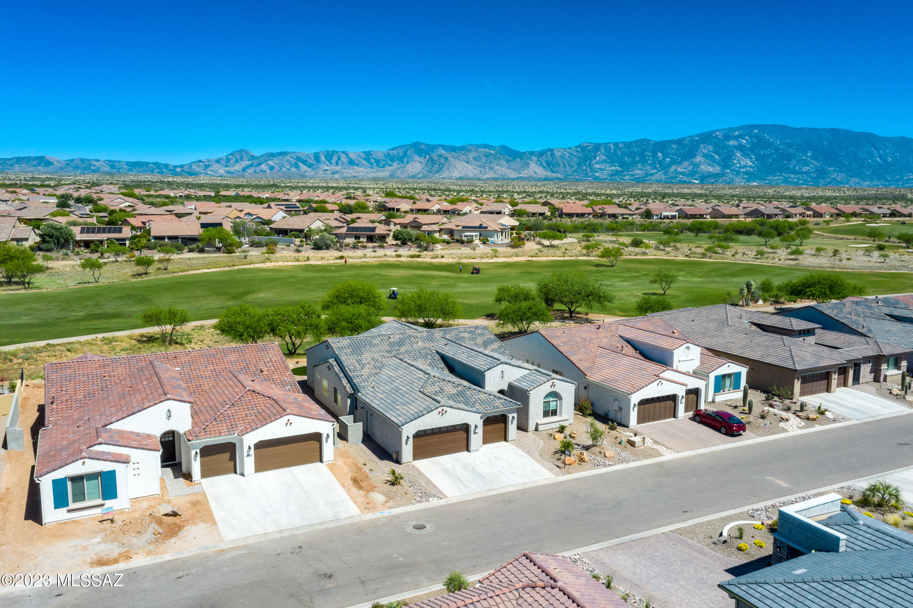 Why wait to Build? This gorgeous Avalon is almost brand new and has barely been lived in. Located right on the golf course, this home captures wonderful views of the course & mountains beyond. Home has over $250k of upgrades including optional 3rd bedroom guest suite, 2' den extension, Upgraded French oak LVP flooring throughout. Chef's Kitchen with double stacked beautiful alder cabinets, high end granite countertops, gorgeous tile backsplash & GE Monogram appliances (including 5 burner gas range, convection oven & microwave) Butler's pantry includes sink, wine fridge & large walk-in pantry. Open great room with built-in cabinetry & floating display shelves. Dining area with built-in buffet & designer lighting throughout incl. under cabinet lighting. Sliding glass wall provides seamless indoor/outdoor living perfect for entertaining. Huge primary suite with upgraded shower, dual vanities, soaking tub & custom walk-in closet. Two additional bedrooms with ensuite baths. Huge den/office. Oversized three car garage. Large covered patio with outdoor fireplace, extended brick paver patio, built in BBQ, electric sunshades & brand-new landscaping. This home has it all. Add to that the wonderful amenities of this premier active adult community with golf, tennis, pickleball, indoor/outdoor pools, hot tub, fitness center & on-site restaurants. Move in Ready!